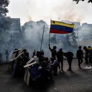 Venezuelan opposition activists clash with the Bolivarian National Guard during protest against government of President Nicolas Maduro, in Caracas, on May 18, 2017. On Monday Venezuelans launched a seventh week of anti-government demonstrations by blocking roads, vowing not to budge all day in protest at a deadly political and economic crisis. (Carlos Becerra/Anadolu Agency/Getty Images)