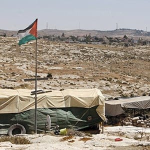 A view of the Palestinian flag and tents in Susiya village, south of the West Bank city of Hebron, on July 20, 2015. (Mussa Qawasma/Reuters)