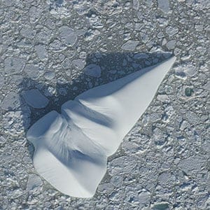 Cone shaped and rounded ice berg embedded in pack ice in Alexis Bay Labrador Newfoundland.