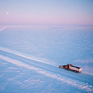 Snowplough in action widening road, high view across landscape,Canada