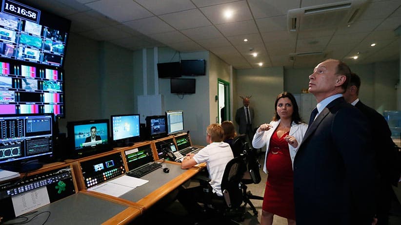 Russian President Vladimir Putin, right, visits the new headquarters of the Russia Today television channel in Moscow, Russia in June 2013