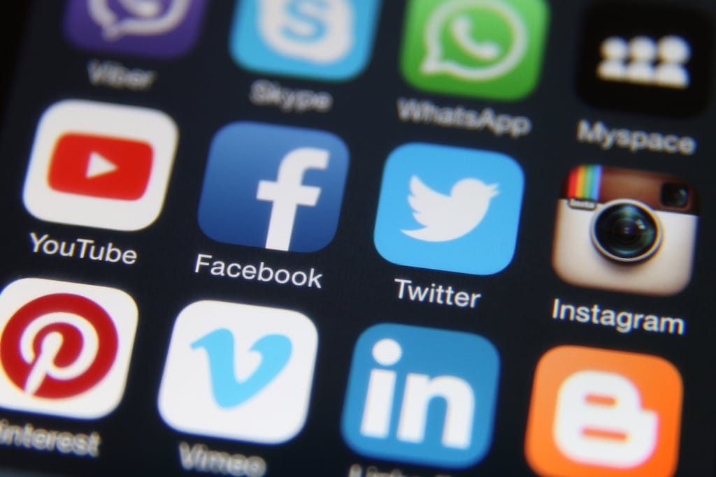 Berlin, Germany - October 10, 2015: Apple iPhone 6 screen with social media internet application icons Facebook, Twitter, Instagram, LinkedIn, Vimeo, Youtube, Skype, Blogger, Pinterest etc.