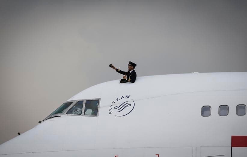 A Garuda Indonesia's pilot takes a selfie on the cockpit of the Boeing 747-400 with registration number PK-GSH during a ceremony on the tarmac of GMF AeroAsia at Soekarno-Hatta international airport in Tangerang, Indonesia, 09 October 2017. According to media reports, the GMF AeroAsia released 10 percent of its shares during its initial public offering (IPO), to improve its financial performance. (Mast Irham/EPA)
