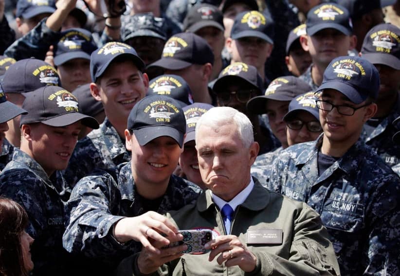 In Wednesday, April 19, 2017, photo, U.S. Vice President Mike Pence, center right at bottom, takes a selfie with U.S. servicemen on the flight deck of U.S. navy nuclear-powered aircraft carrier USS Ronald Reagan, at the U.S. Navy's Yokosuka base in Yokosuka, south of Tokyo. (Eugene Hoshiko/AP)