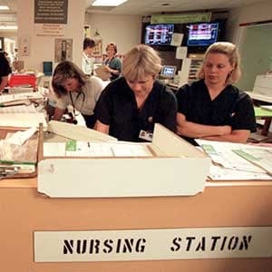 will try and mark the minis .1 nurse Cathy Johnson in red , pink uniform .2 Badil Ali 10 and his mother Mrs Roohi Jamal eating potatoe chips as he waits attention 3Donna Bond with baby Shannon 5 weeks and nurse Johnson 4 nurses also interviewed Angie Ganter dark outfit and Carol Shelton white outfit , together and singles 5 general scenes at nurse work station 6 markings on board in emerg indicating the two states of emergency and the times , i.e. critical bypass etc 7 ambulances outside (Photo by Ron Bull/Toronto Star via Getty Images)