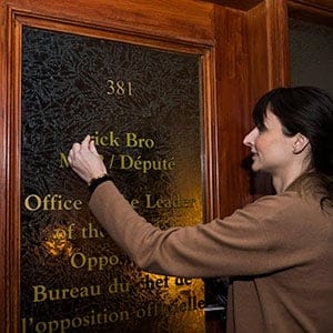 A Queen's Park legislative staff member takes down former PC leader Patrick Brown's office name at Queen's Park in Toronto on Friday, January 26, 2018. Brown stepped down as PC leader following sexual misconduct allegations. THE CANADIAN PRESS/Nathan Denette