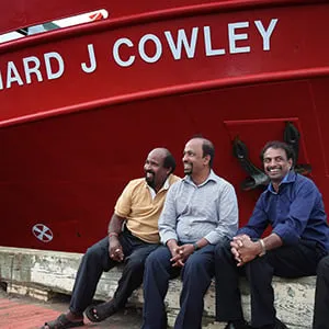 Siva Mehanathan, left to right, Suhapiramam Annalingam, Baskaran Nadarajah and Puvanendran Shanmuga sit in front of the Coast Guard ship Leonard J Cowley in St. John's, Newfoundland on Thursday, Aug. 11, 2016. 30 years ago, today, 155 Tamil Refugees were rescued off the coast of Newfoundland. (Paul Daly/CP)