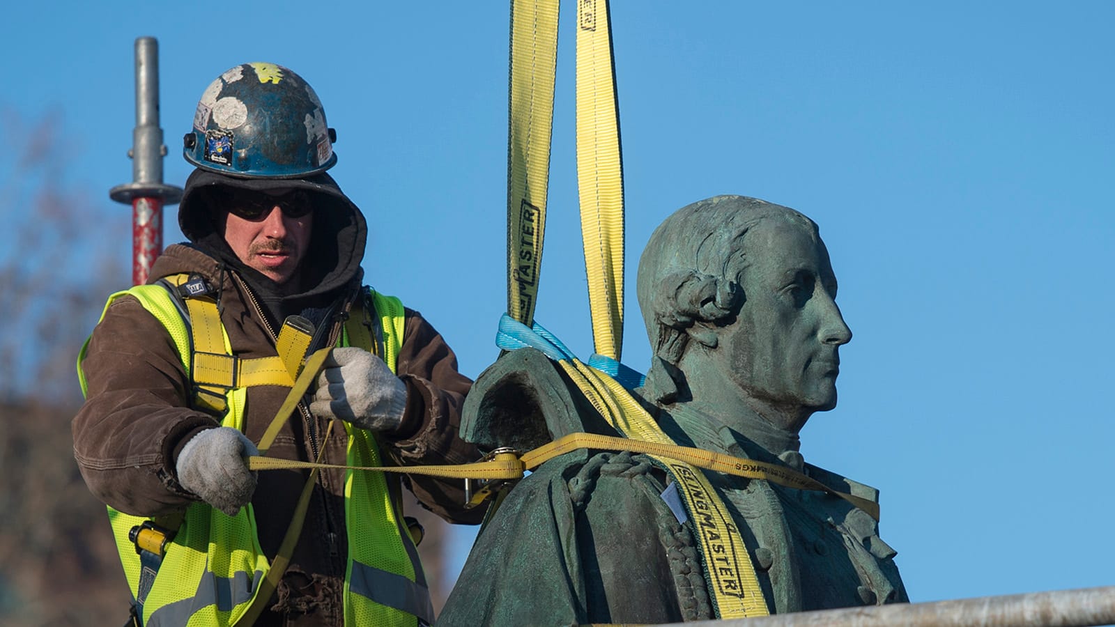 A worker prepares to remove the statue of Edward Cornwallis in Halifax on Wednesday, January 31, 2018 after city council voted to put the cast in storage until a more permanent decision can be made. Many have long called for the contentious statue's removal because, as governor of Nova Scotia, Cornwallis issued a scalping proclamation in 1749, offering a cash bounty to anyone who killed a Mi'kmaw man, woman, or child. (Photograph by Darren Calabrese)