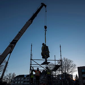 The statue of Edward Cornwallis is removed from its pedestal in Halifax on Wednesday, January 31, 2018 after city council voted to put the cast in storage until a more permanent decision can be made. Many have long called for the contentious statue's removal because, as governor of Nova Scotia, Cornwallis issued a scalping proclamation in 1749, offering a cash bounty to anyone who killed a Mi'kmaw man, woman, or child. (Photograph by Darren Calabrese)