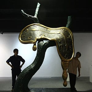 WENZHOU, CHINA - JULY 15: (CHINA OUT) Workers stand in front of the sculpture 'Profile of Time' of Spanish artist Salvador Dali at the Salvador Dali Art Exhibition on July 15, 2009 in Wenzhou of Zhejiang Province, China. The exhibition which is scheduled to run from July 18 to September 10, will display 24 sculptures and 21 prints of Dali. (Photo by China Photos/Getty Images)