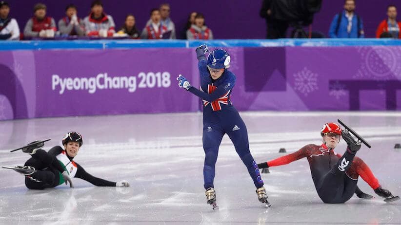 speed skaters, two of them falling down