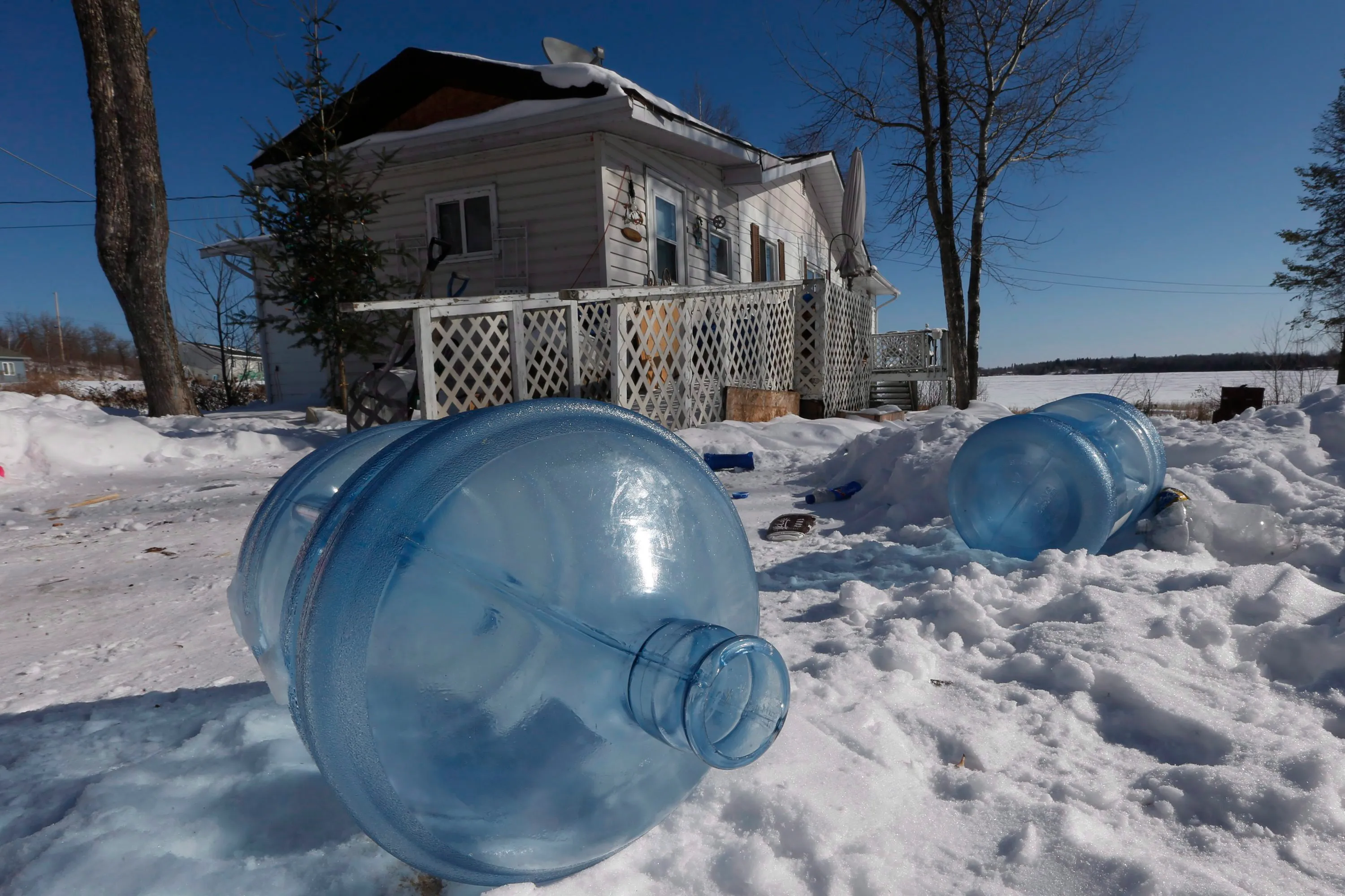 Empty 20 litre water bottles sit outside Laura Green's house waiting for pickup and refilling Wednesday, February 25, 2015. The Shoal Lake community, despite supplying water to the city of Winnipeg, is under a boil water advisory and lacks year round road access. THE CANADIAN PRESS/John Woods