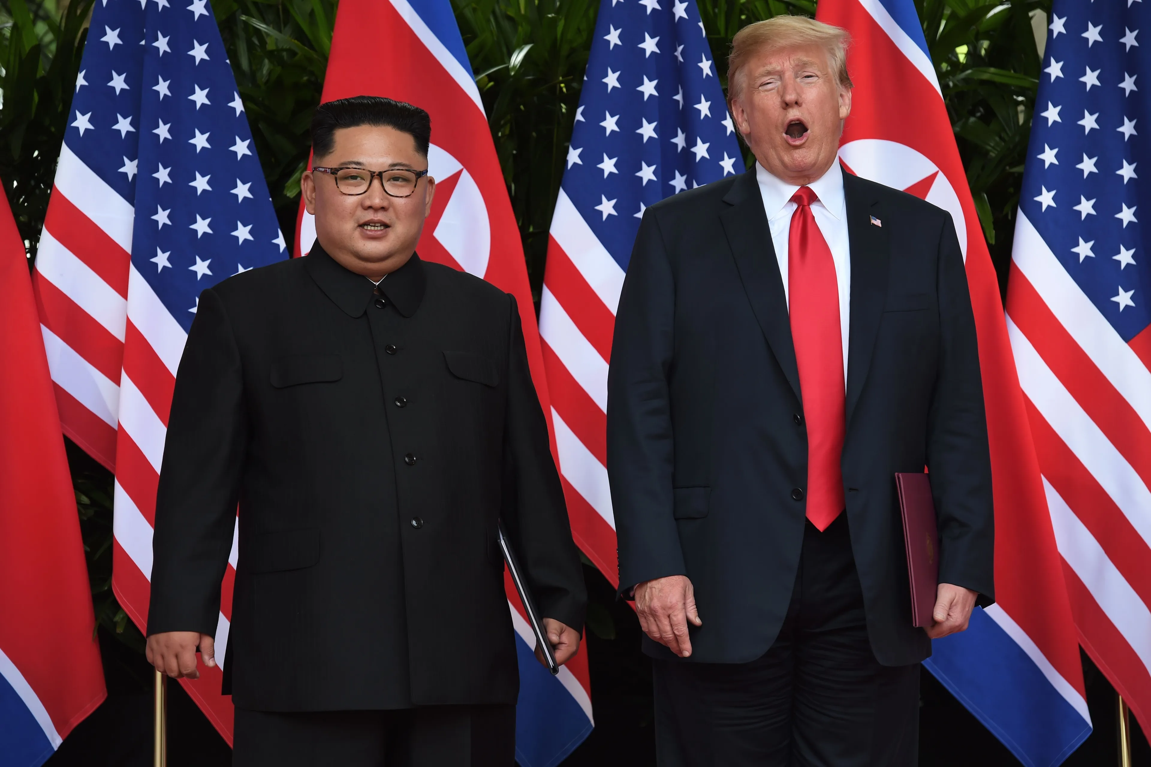 North Korea's leader Kim Jong Un poses with US President Donald Trump after taking part in a signing ceremony at the end of their historic US-North Korea summit in Singapore on June 12, 2018. (Anthony Wallace/AFP/Getty Images)
