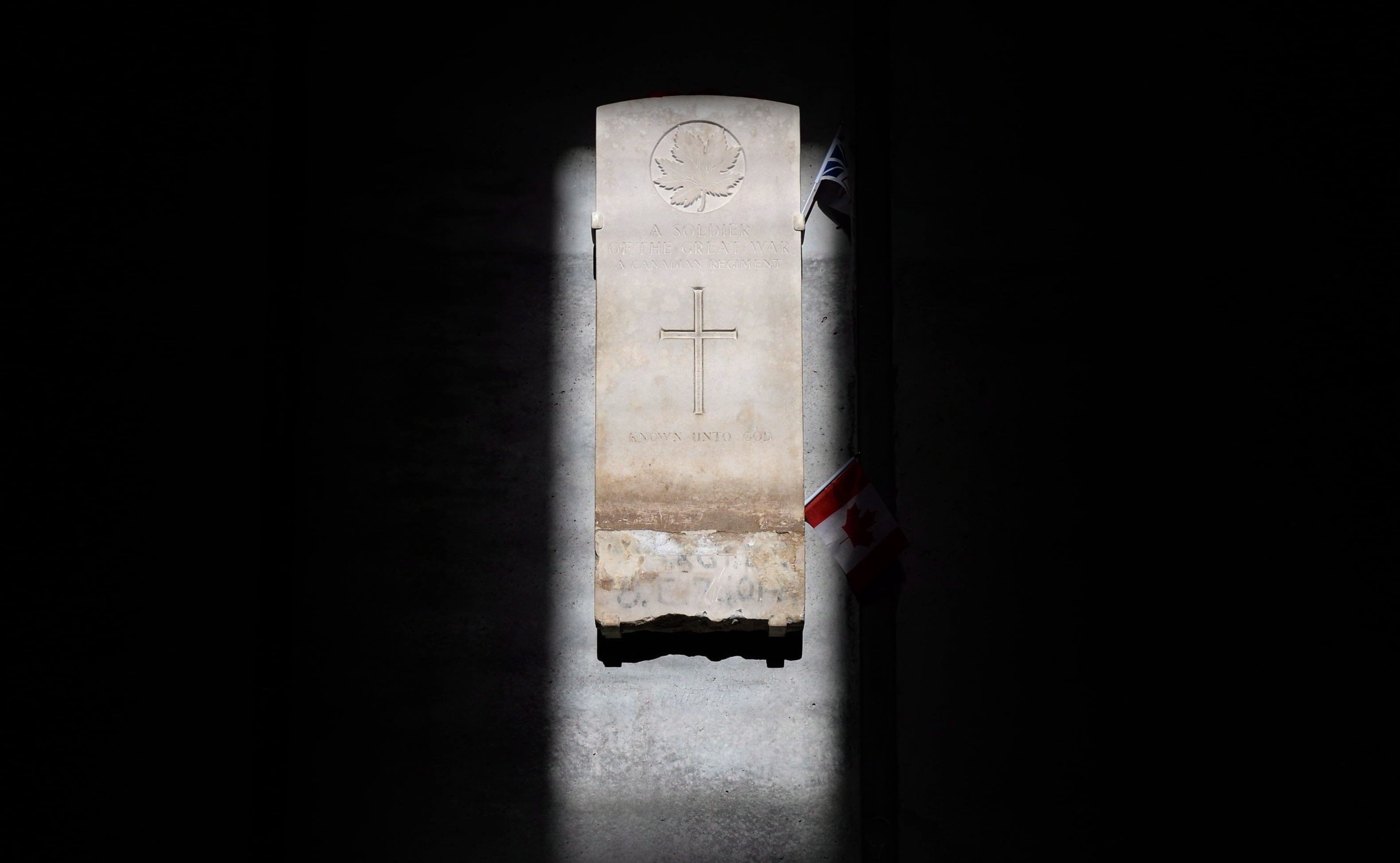 The sun hits the headstone from the grave of Canada's Unknown Soldier in the Memorial Hall at the Canadian War Museum in Ottawa on Monday, November 10, 2014. The Memorial Hall is designed so the headstone is lit by the sun perfectly on Remembrance Day at 11:00 am. THE CANADIAN PRESS/Sean Kilpatrick