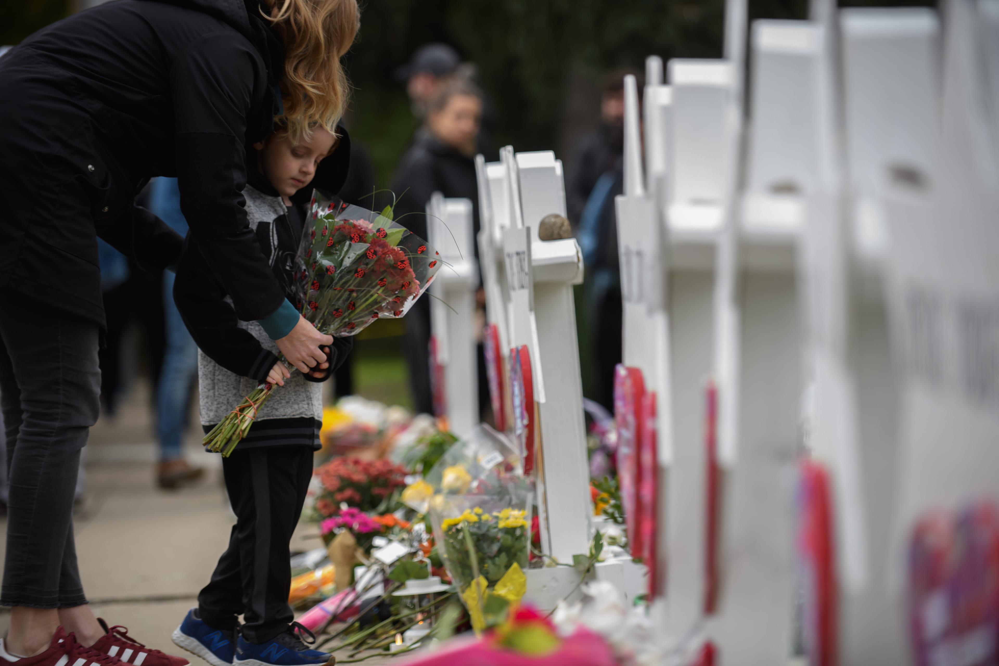 A mother and child place flowers at a memorial for victims of the mass shooting that killed 11 people and wounded 6 at the Tree Of Life Synagogue on October 29, 2018 in Pittsburgh, Pennsylvania. (Jeff Swensen/Getty Images)