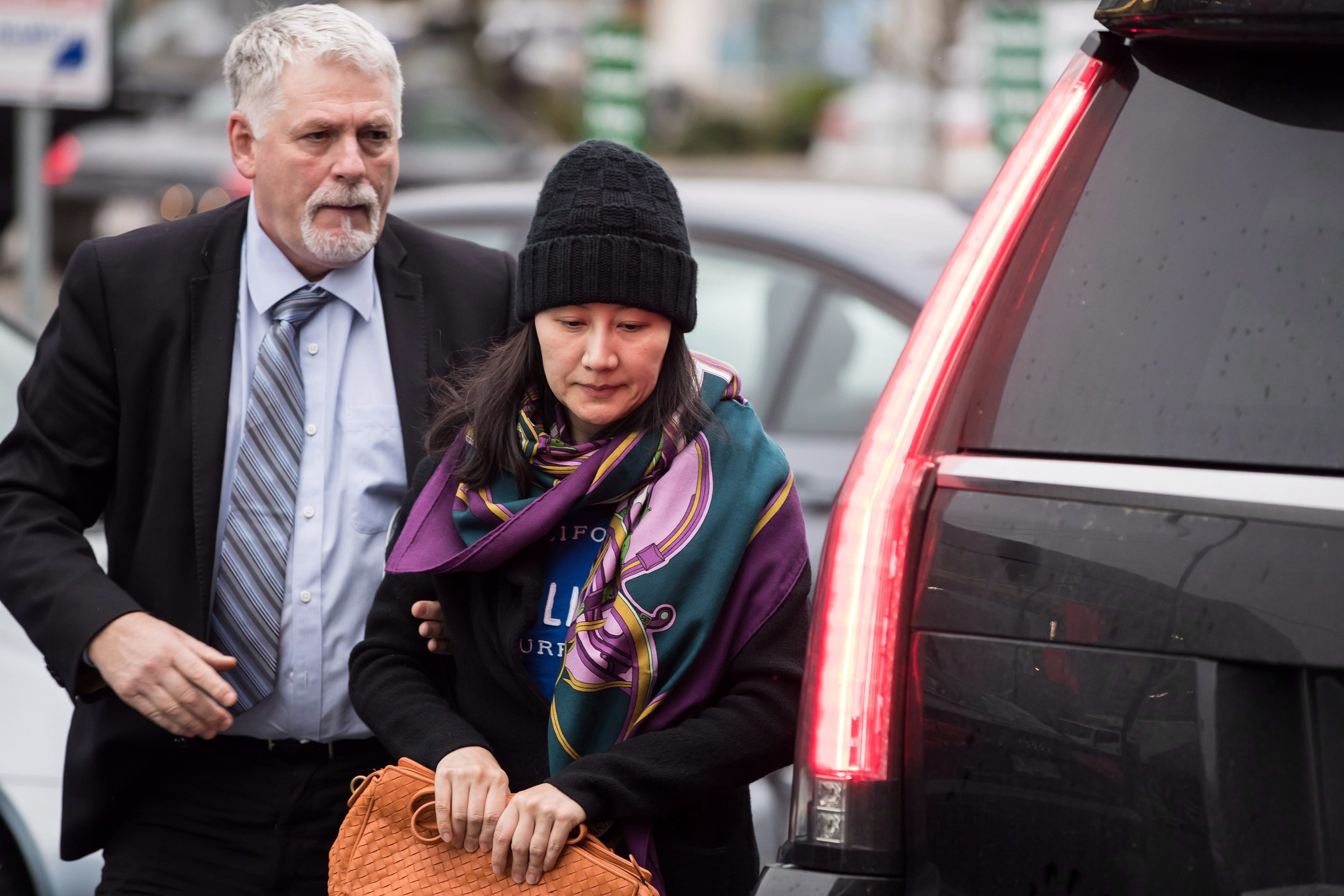 Meng Wanzhou, right, with a member of her private security detail in Vancouver. (Darryl Dyck/CP)