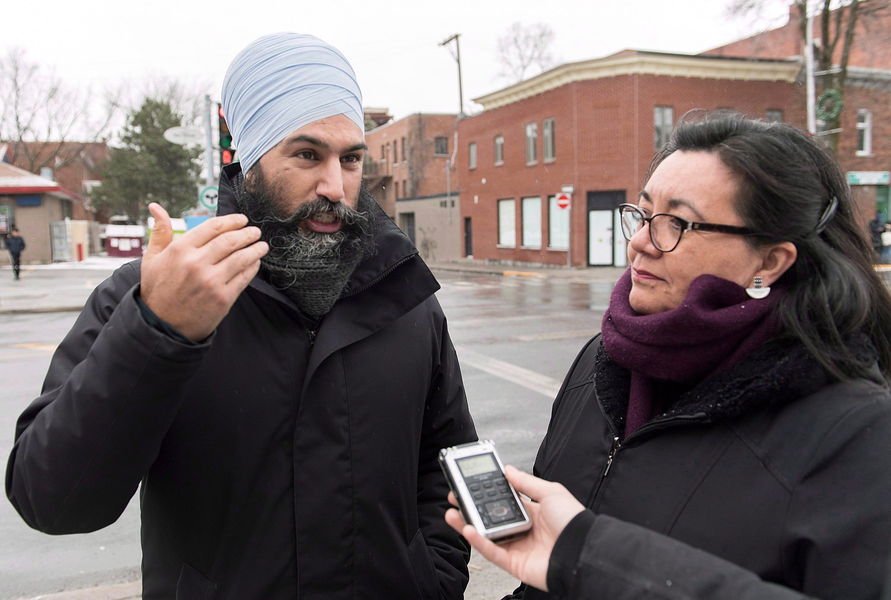 NDP Leader Jagmeet Singh and NDP candidate for the riding of Outremont Julia Sanchez speak to reporters during a tour of the Montreal borough on Dec. 22, 2018. (THE CANADIAN PRESS/Graham Hughes)