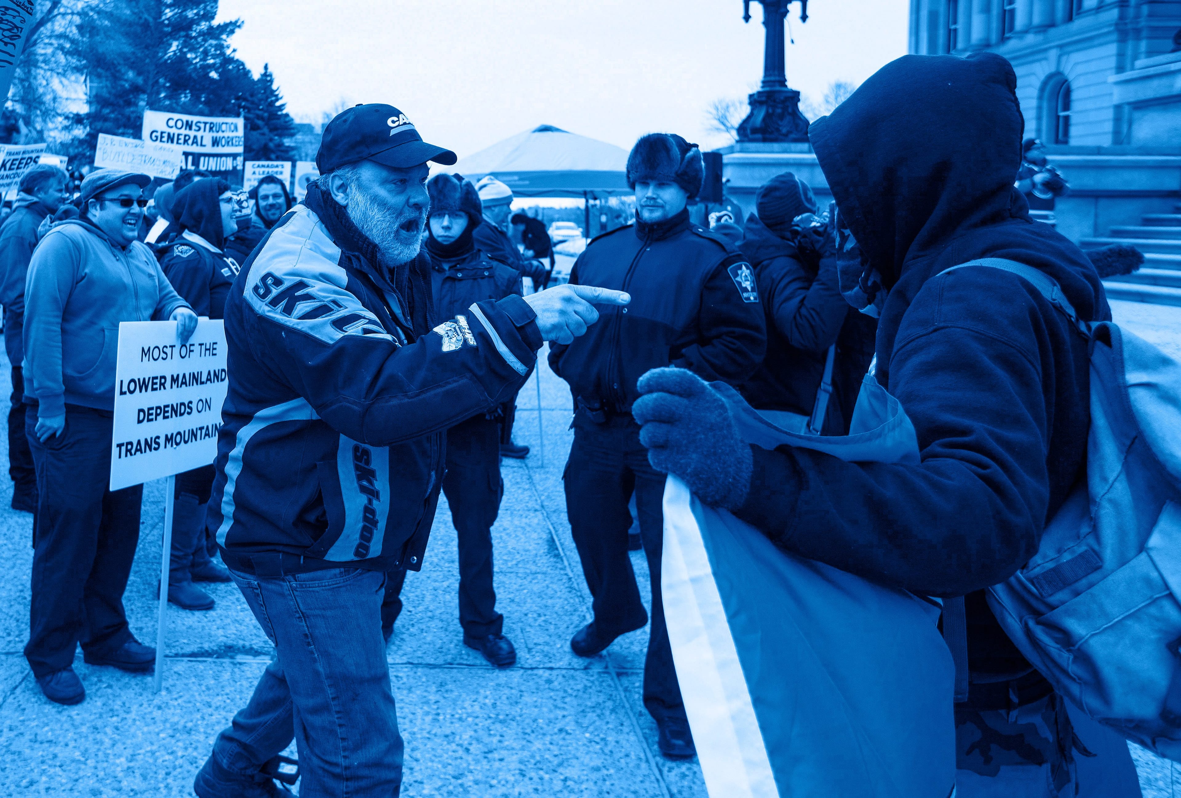A pipeline supporter confronts an anti-pipeline protestor, during a rally in Edmonton Alta., on April 12, 2018. (Jason Franson/CP)