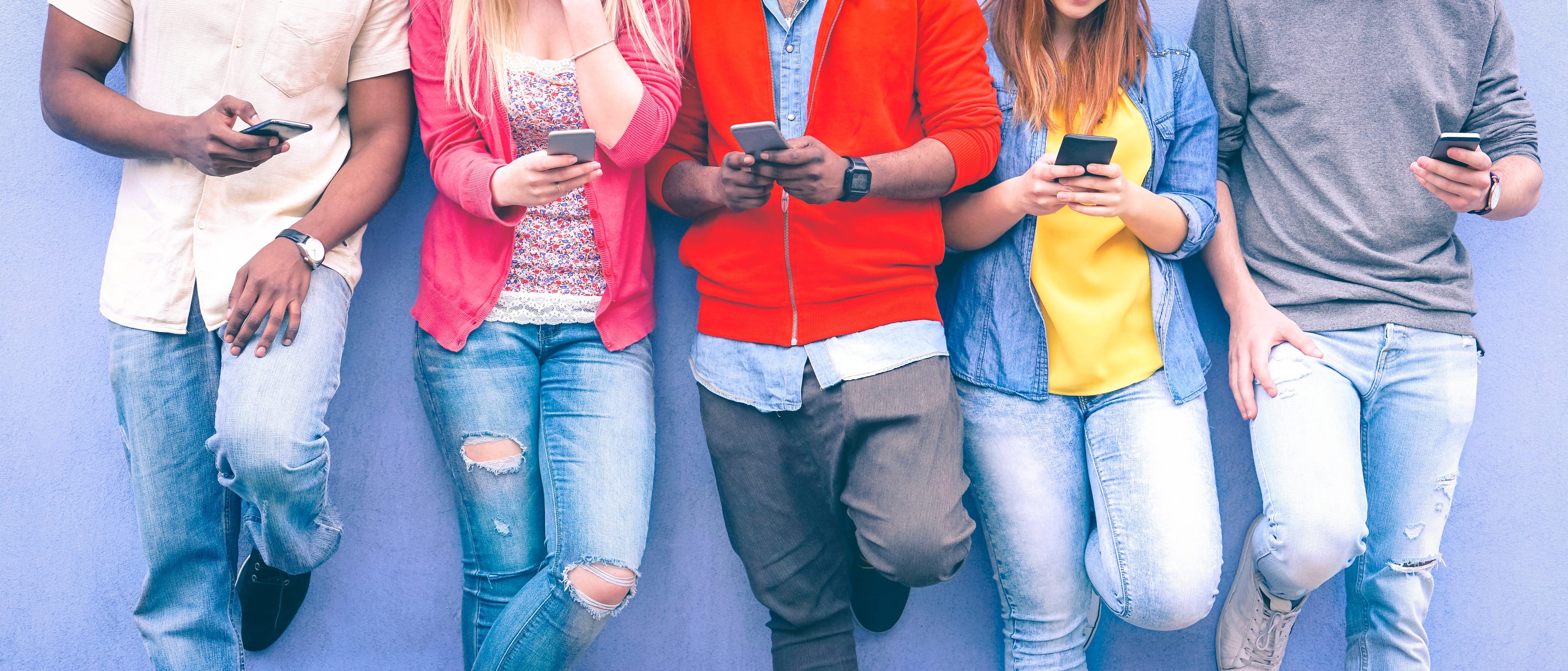 Teenagers who may not let a cellphone ban stop them from doing what they're doing here. (Shutterstock)