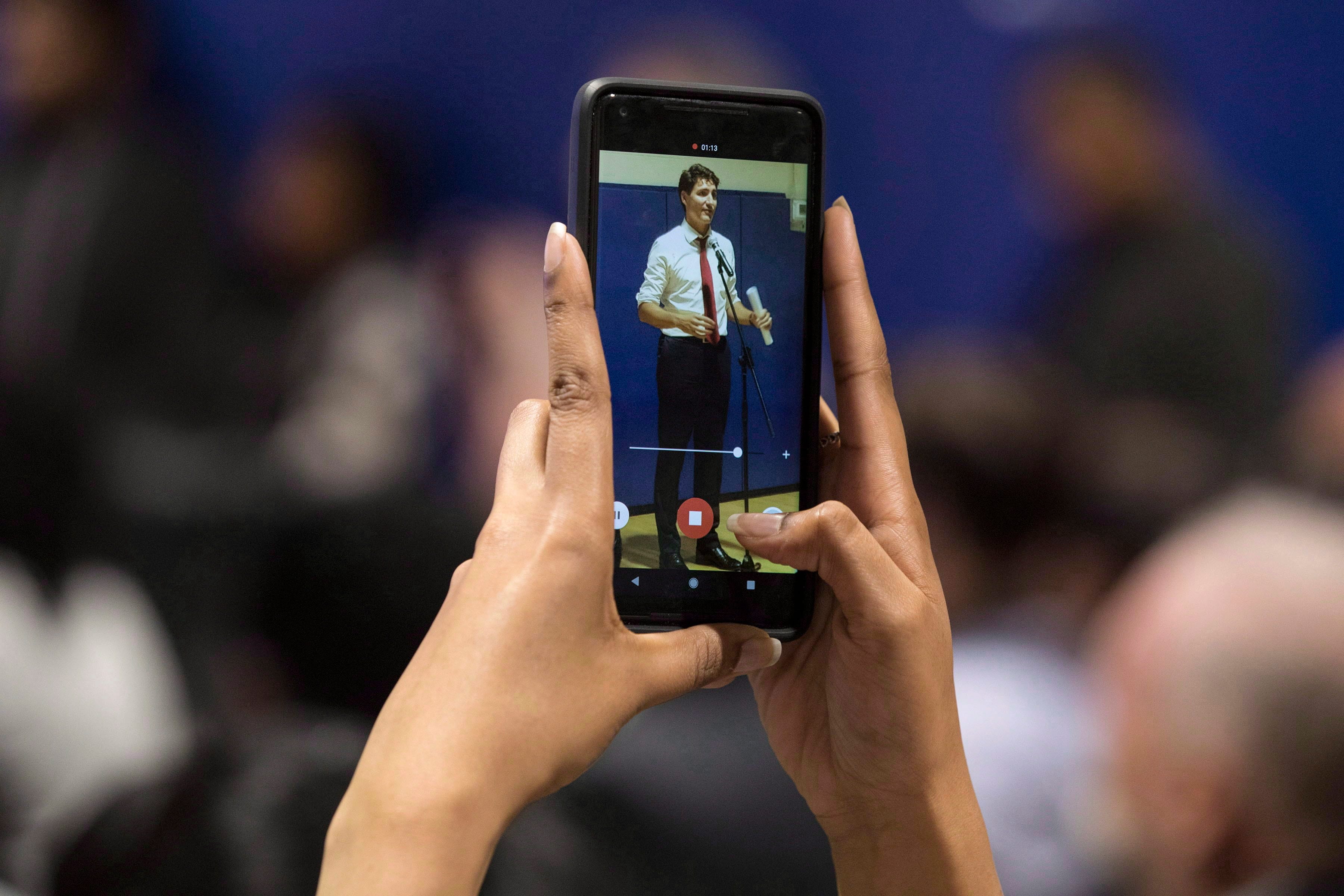 Canadian Prime Minister Justin Trudeau remarks are recorded on a guest's phone as he visits the South Asian Autism Awareness Centre in Scarborough, Ontario on Friday September 21, 2018. THE CANADIAN PRESS/Chris Young