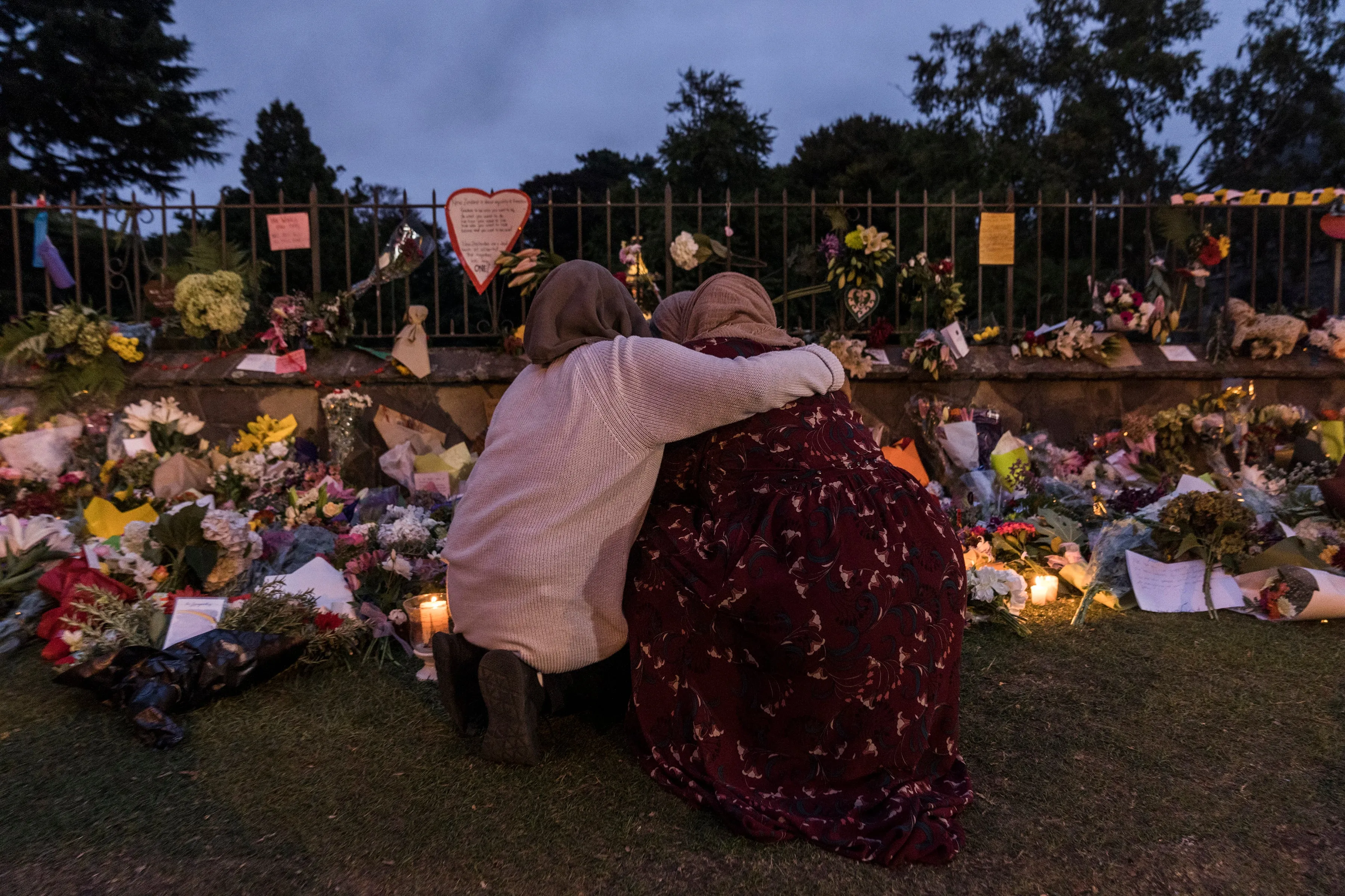 Mourners comfort each other at a makeshift memorial near Al Noor mosque in Christchurch, New Zealand, March 17, 2019. (Adam Dean/The New York Times/Redux)