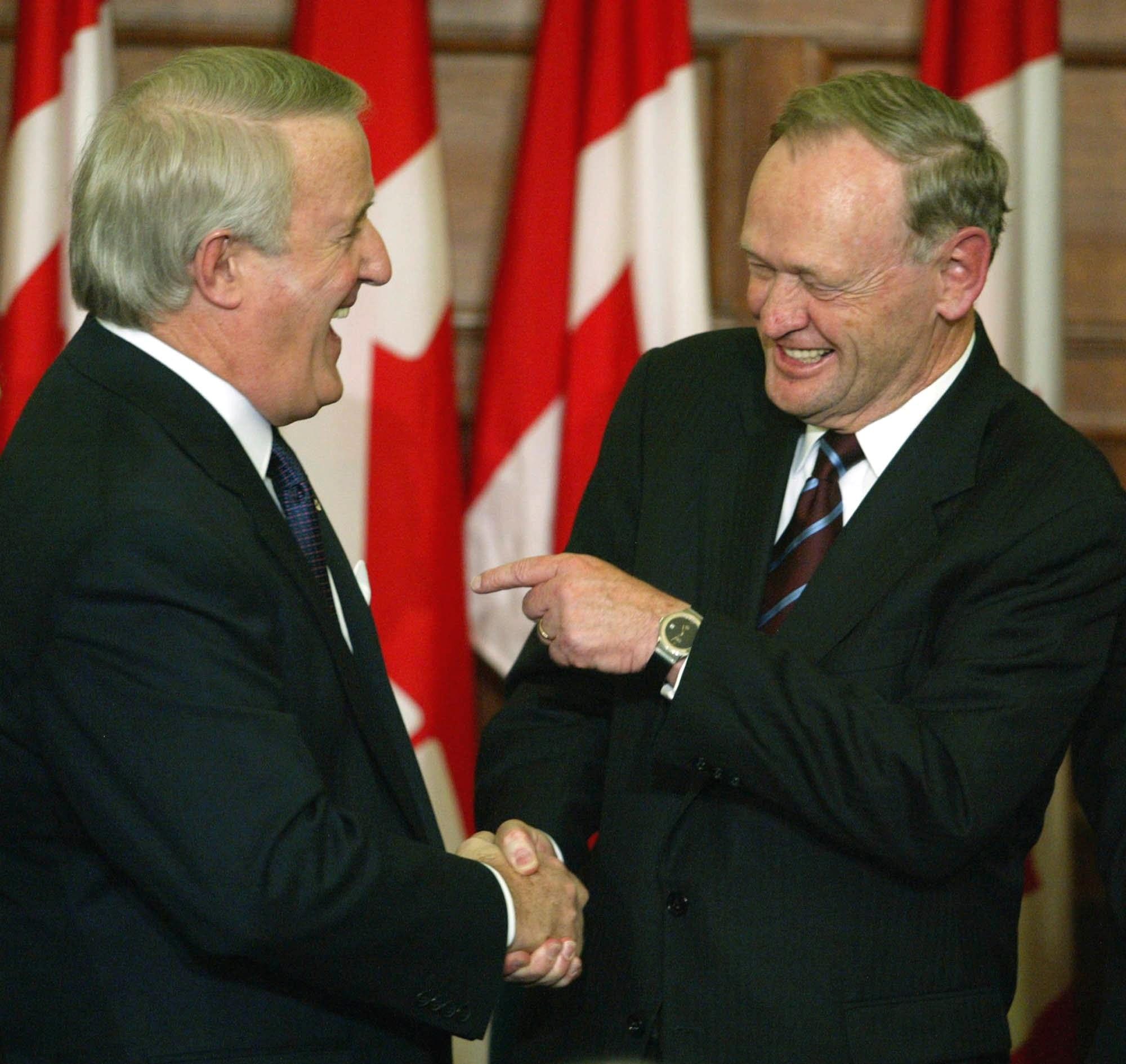 Prime Minister Jean Chretien points towards former prime minister Brian Mulroney as they share a laugh during an official unveiling ceremony of Mulroney's official portrait on Parliament Hill in Ottawa Tuesday Nov 19, 2002.(CP PHOTO/Tom Hanson)