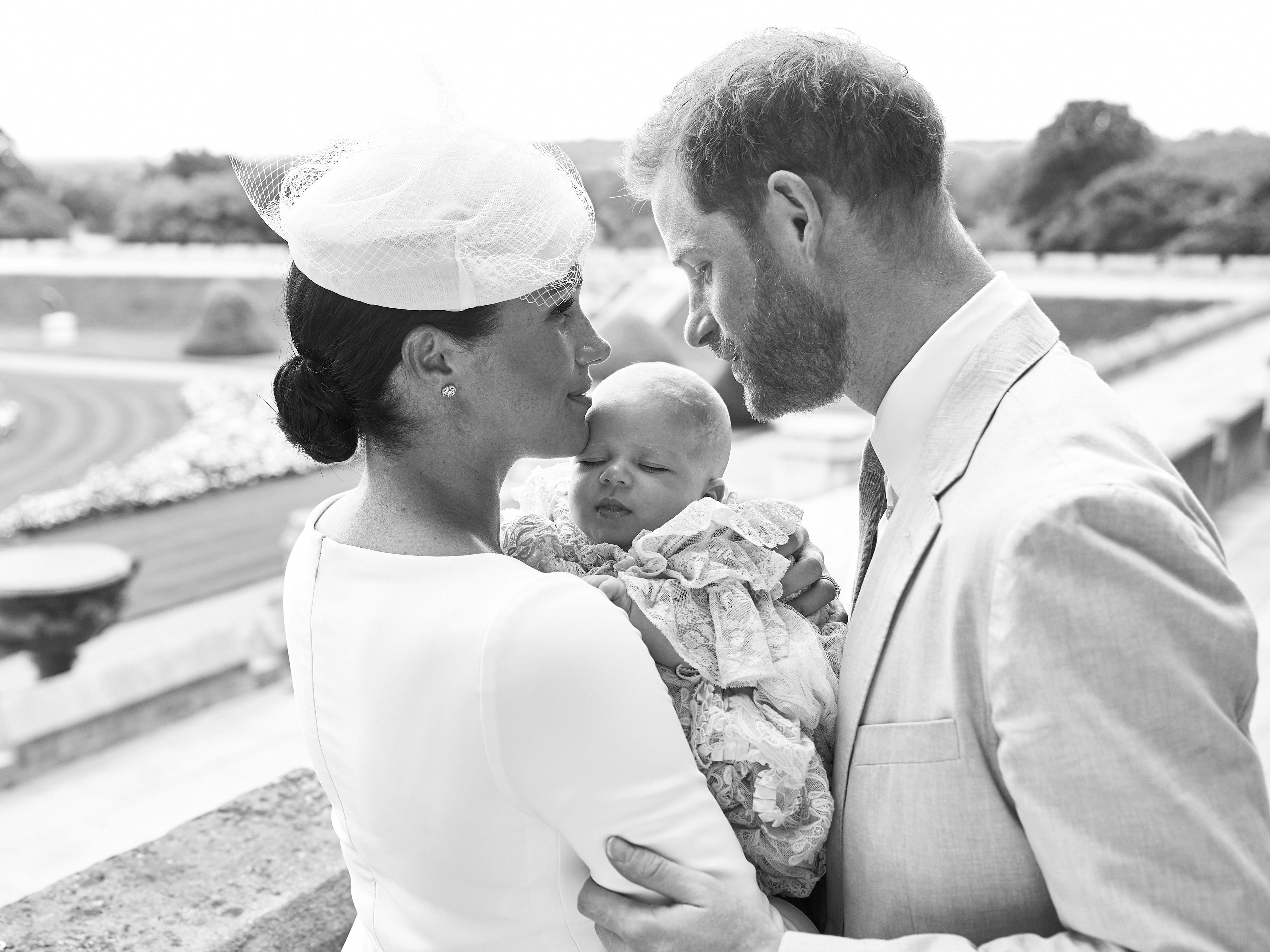 This official handout Christening photograph released by the Duke and Duchess of Sussex shows Britain's Prince Harry, Duke of Sussex (R), and his wife Meghan, Duchess of Sussex holding their baby son, Archie Harrison Mountbatten-Windsor at Windsor Castle with the Rose Garden in the background, west of London on July 6, 2019. (Chris Allerton/AFP/Getty Images)