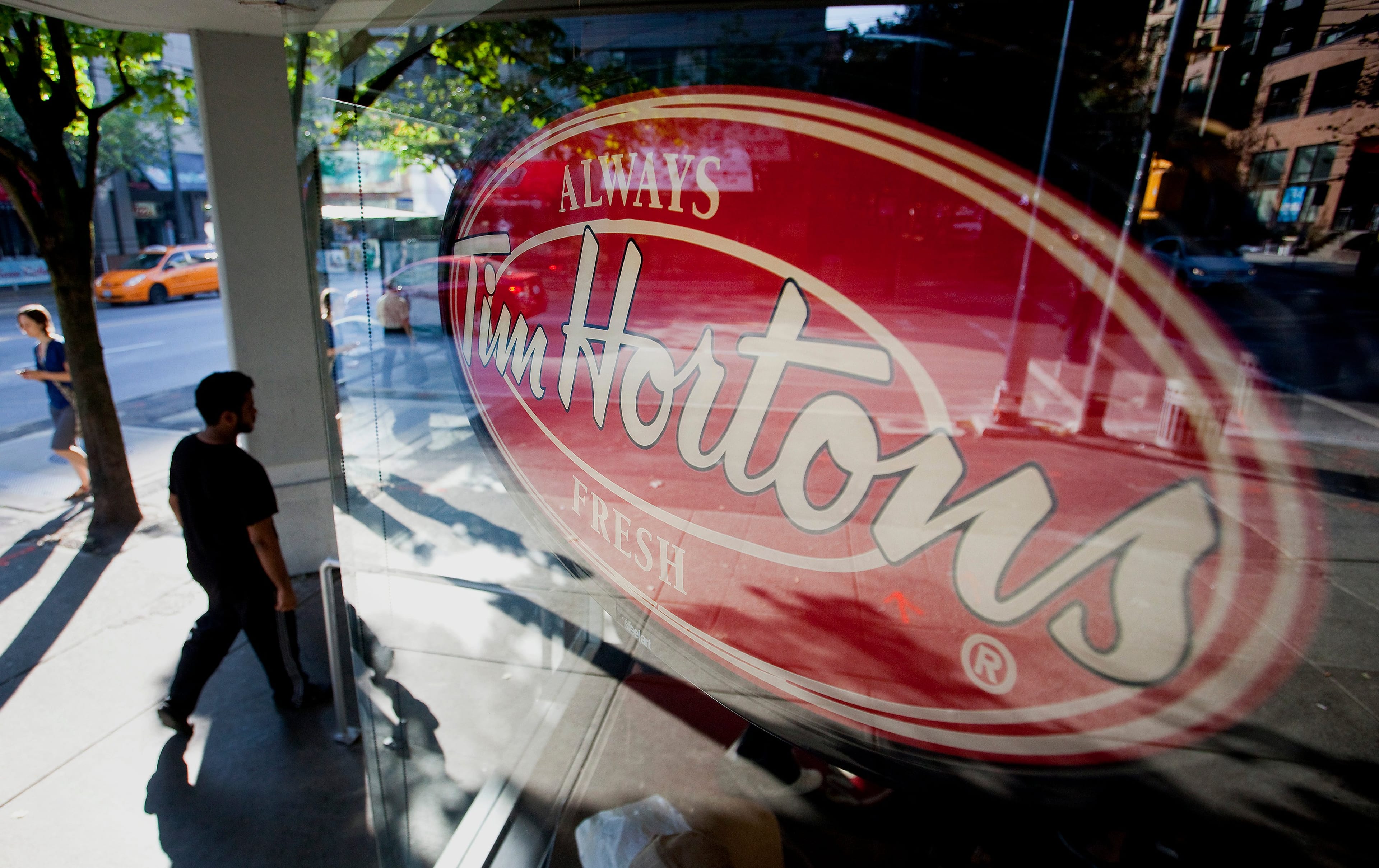 Burger King Worldwide Inc. agreed to acquire Tim Hortons Inc. for about C$12.5 billion ($11.4 billion) in a deal that creates the third-largest fast-food company and moves its headquarters to Canada. (Ben Nelms/Bloomberg/Getty Images)