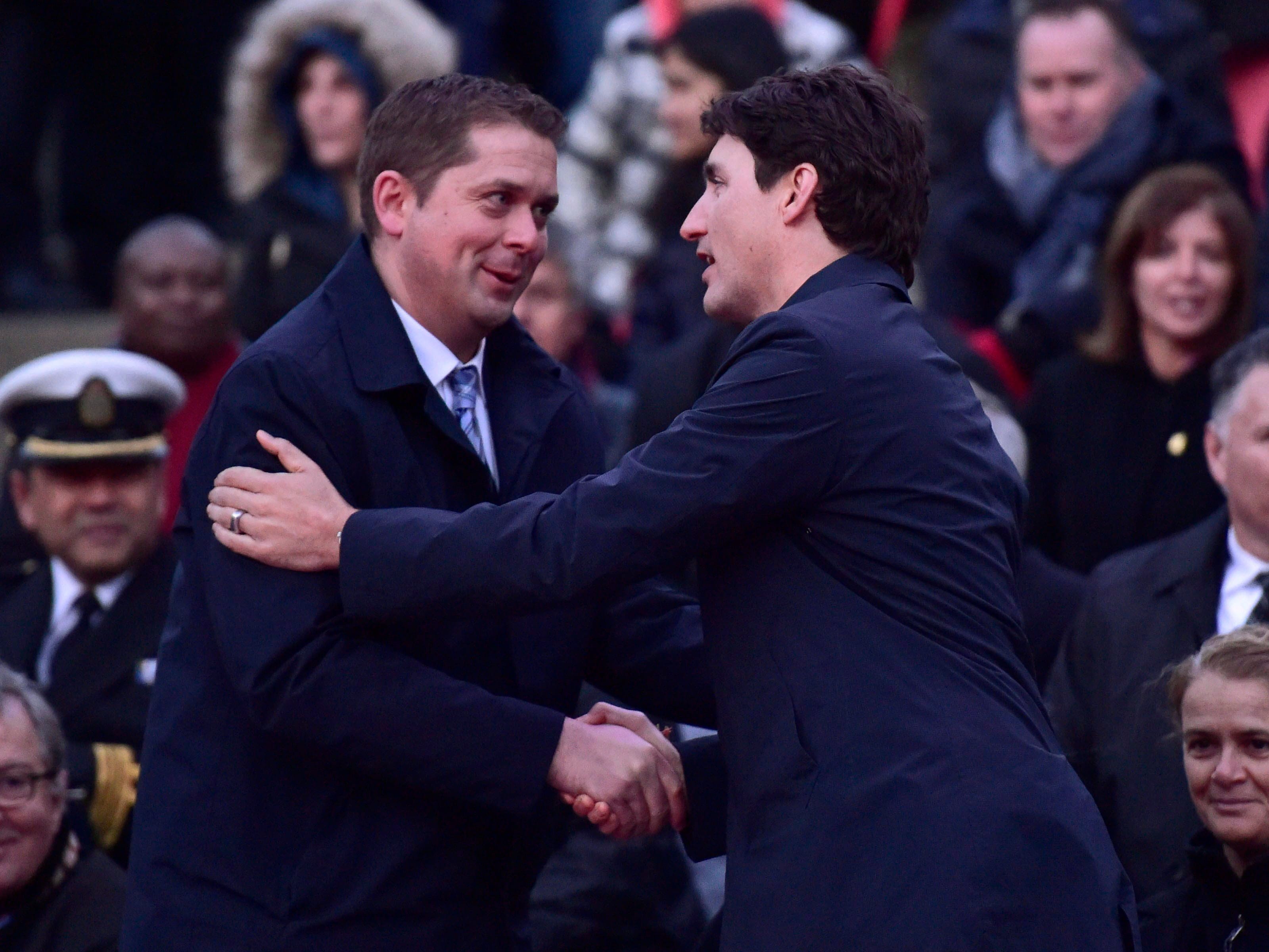 Prime Minister Justin Trudeau greets Federal Conservative Leader Andrew Scheer at a vigil remembering the victims of deadly van attack at Mel Lastman Square in Toronto on Apr. 29, 2018. (CP/Frank Gunn)