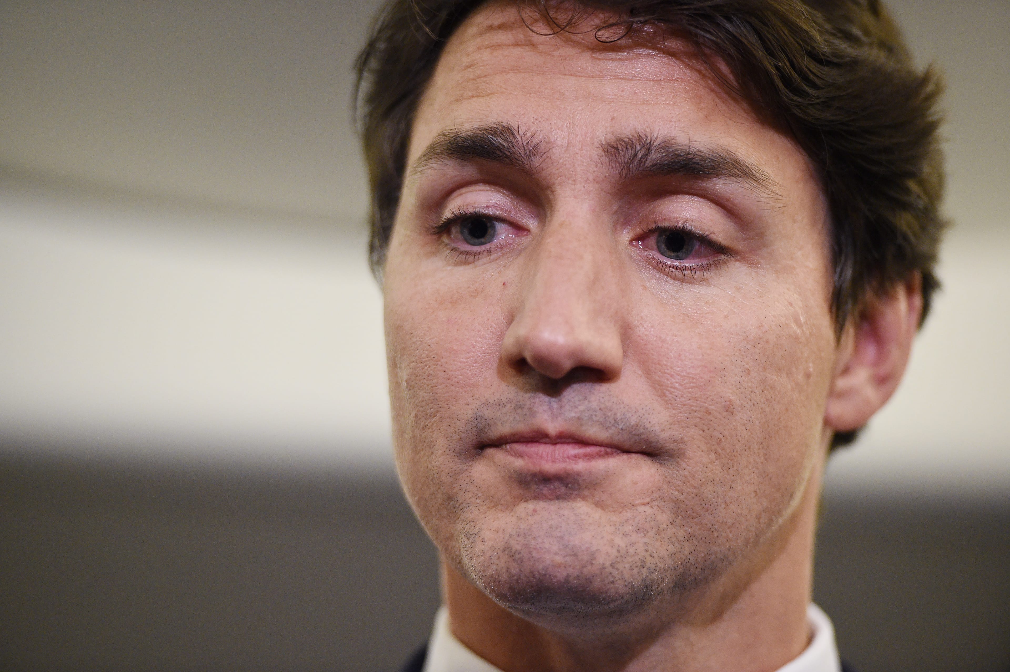 Liberal Leader Justin Trudeau reacts as he makes a statement in regards to photo coming to light of himself from 2001 wearing "brownface" during a scrum on his campaign plane in Halifax, N.S., on Wednesday, September 18, 2019. THE CANADIAN PRESS/Sean Kilpatrick