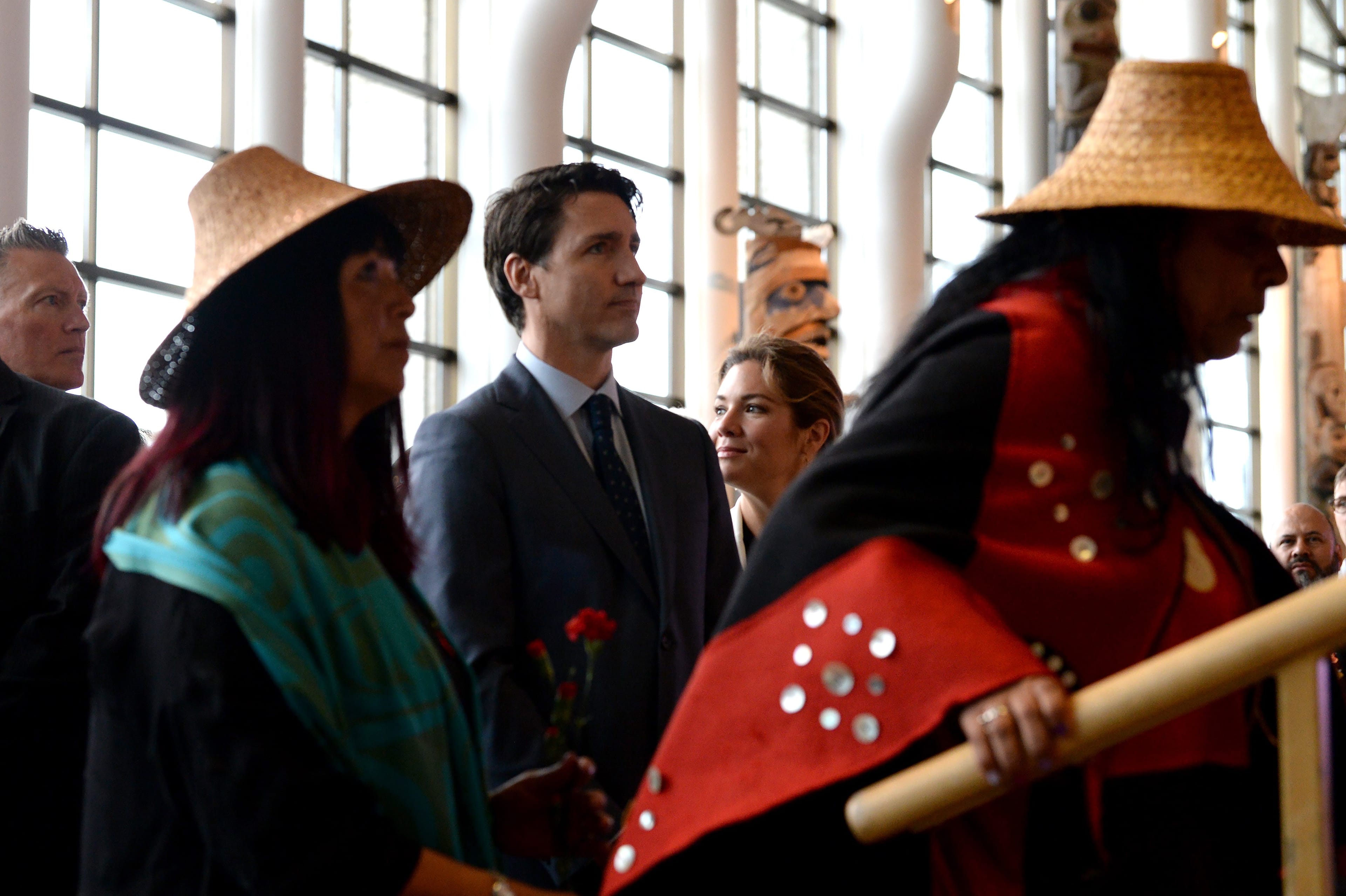 Prime Minister Justin Trudeau looks on as the procession takes the stage at the closing ceremony for the National Inquiry into Missing and Murdered Indigenous Women and Girls in Gatineau, Que., on Jun 3, 2019. (CP/Adrian Wyld)