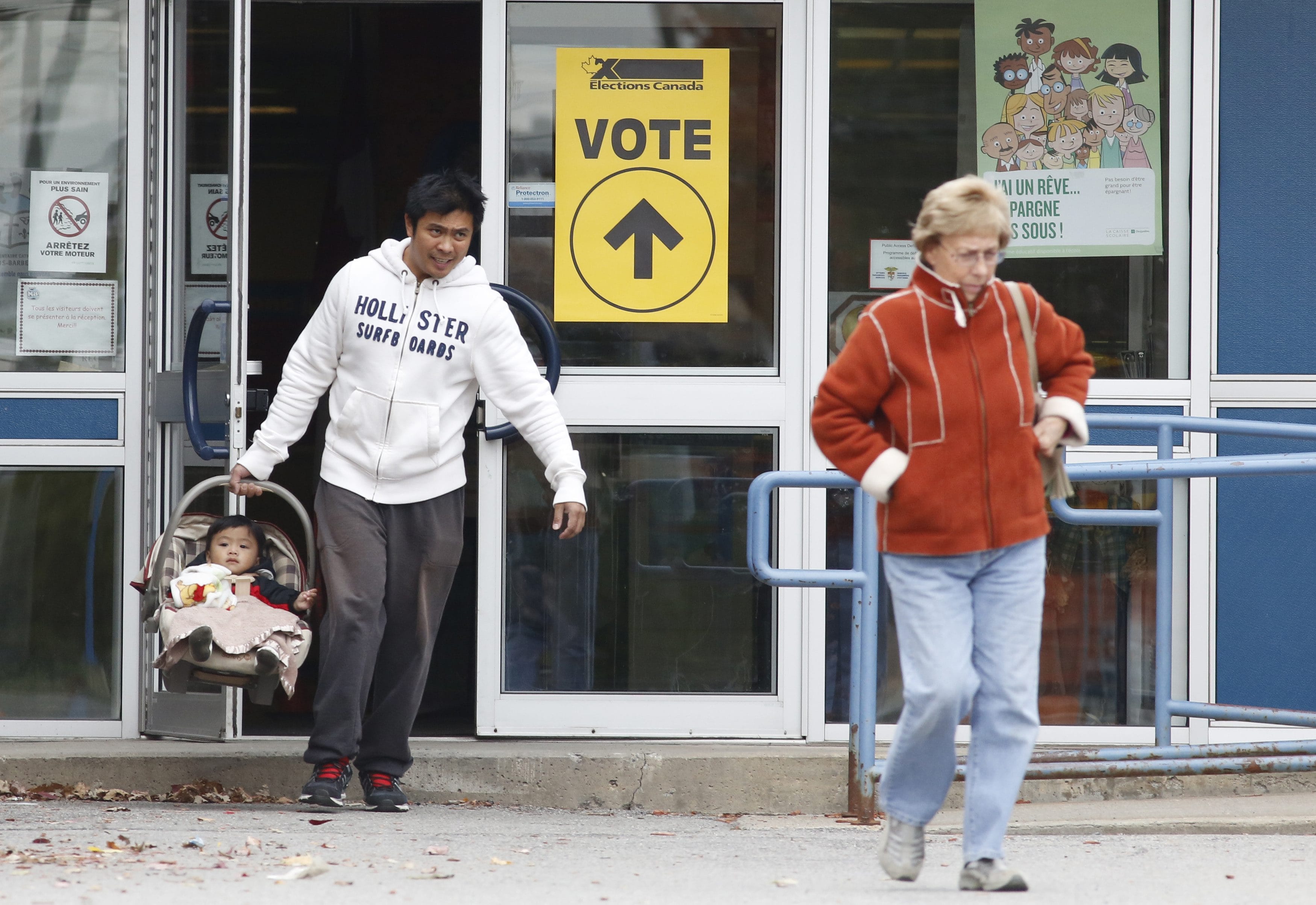 Voters leave the Ecole Marius-Barbeau polling station, in Ottawa, after casting their votes in the Canadian federal election on Oct. 19, 2015. (CP/ Patrick Doyle)