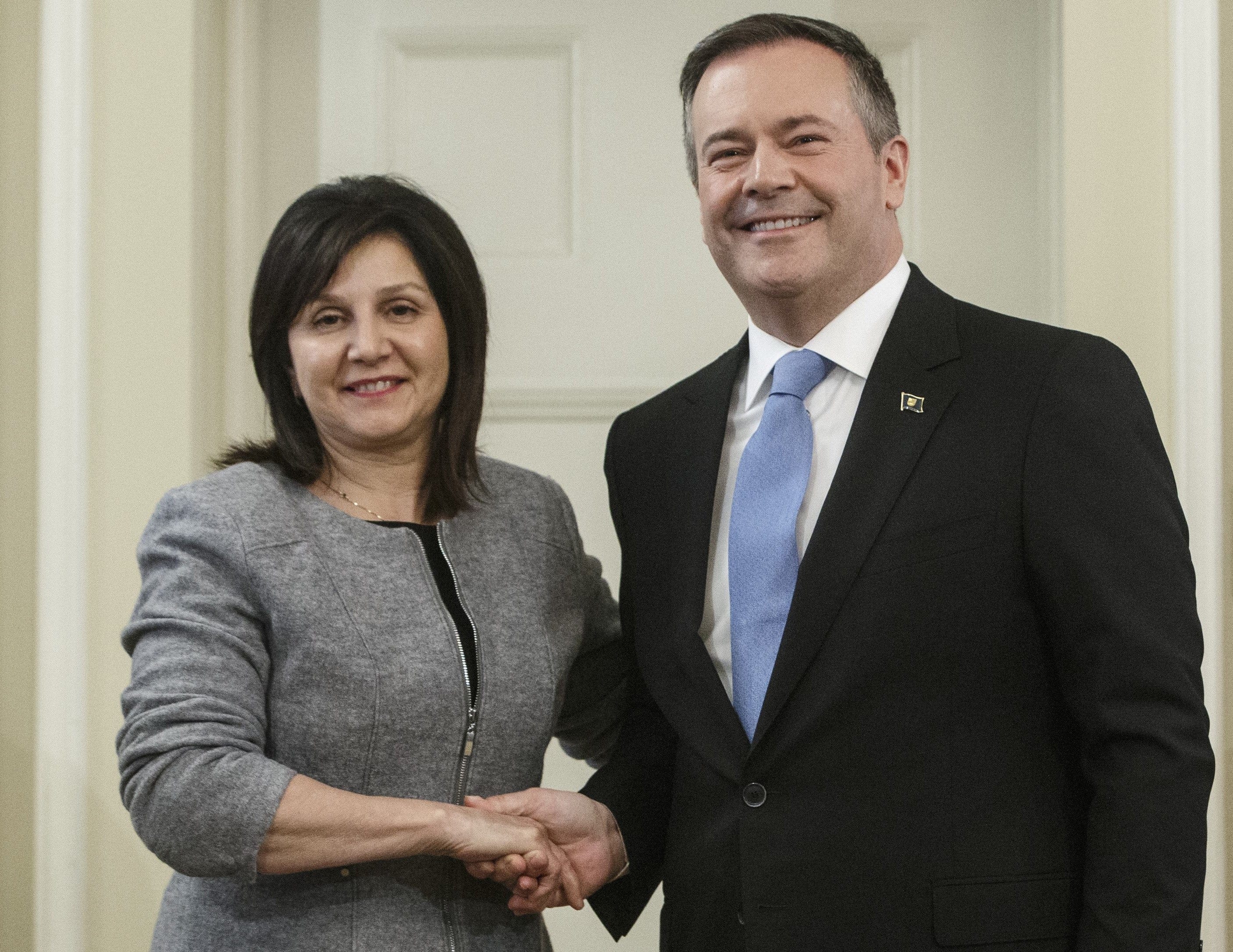 Alberta premier Jason Kenney shakes hands with Adriana LaGrange, Minister of Education after being is sworn into office, in Edmonton on Apr. 30, 2019. (CP/Jason Franson)