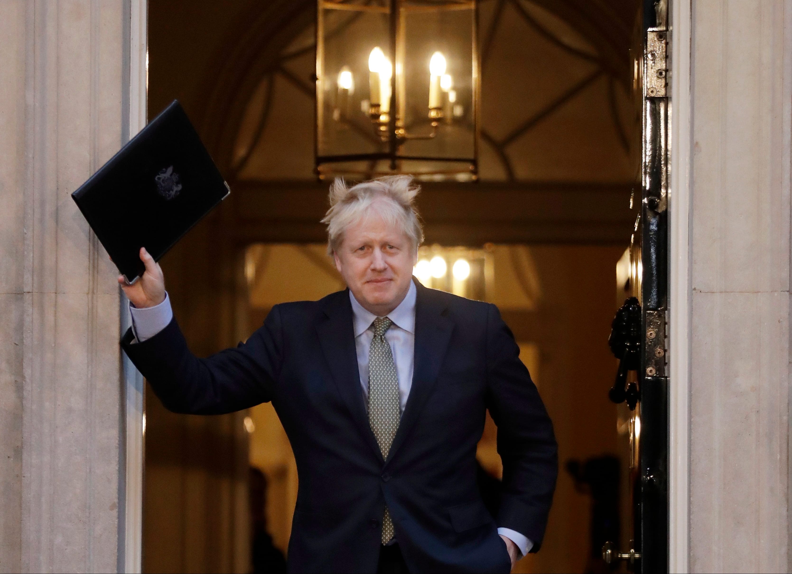Britain's Prime Minister Boris Johnson waves on the steps after speaking outside 10 Downing Street in London on Friday, Dec. 13, 2019. (AP Photo/Matt Dunham)