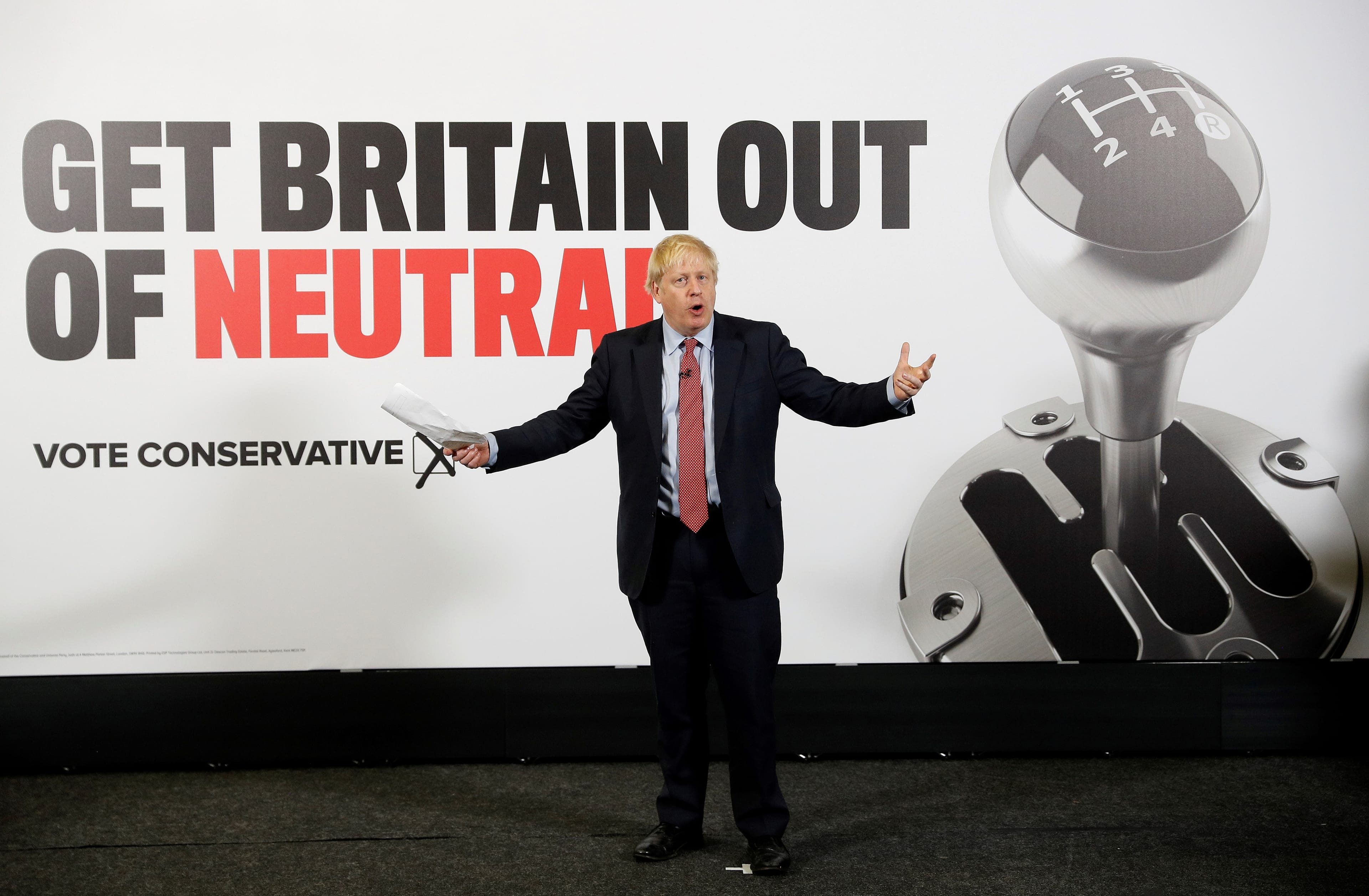 Johnson poses with a Conservative Party campaign poster at the Kent Showground in Detling, southeast England, on Dec. 6, 2019. (PETER NICHOLLS/POOL/AFP via Getty Images)