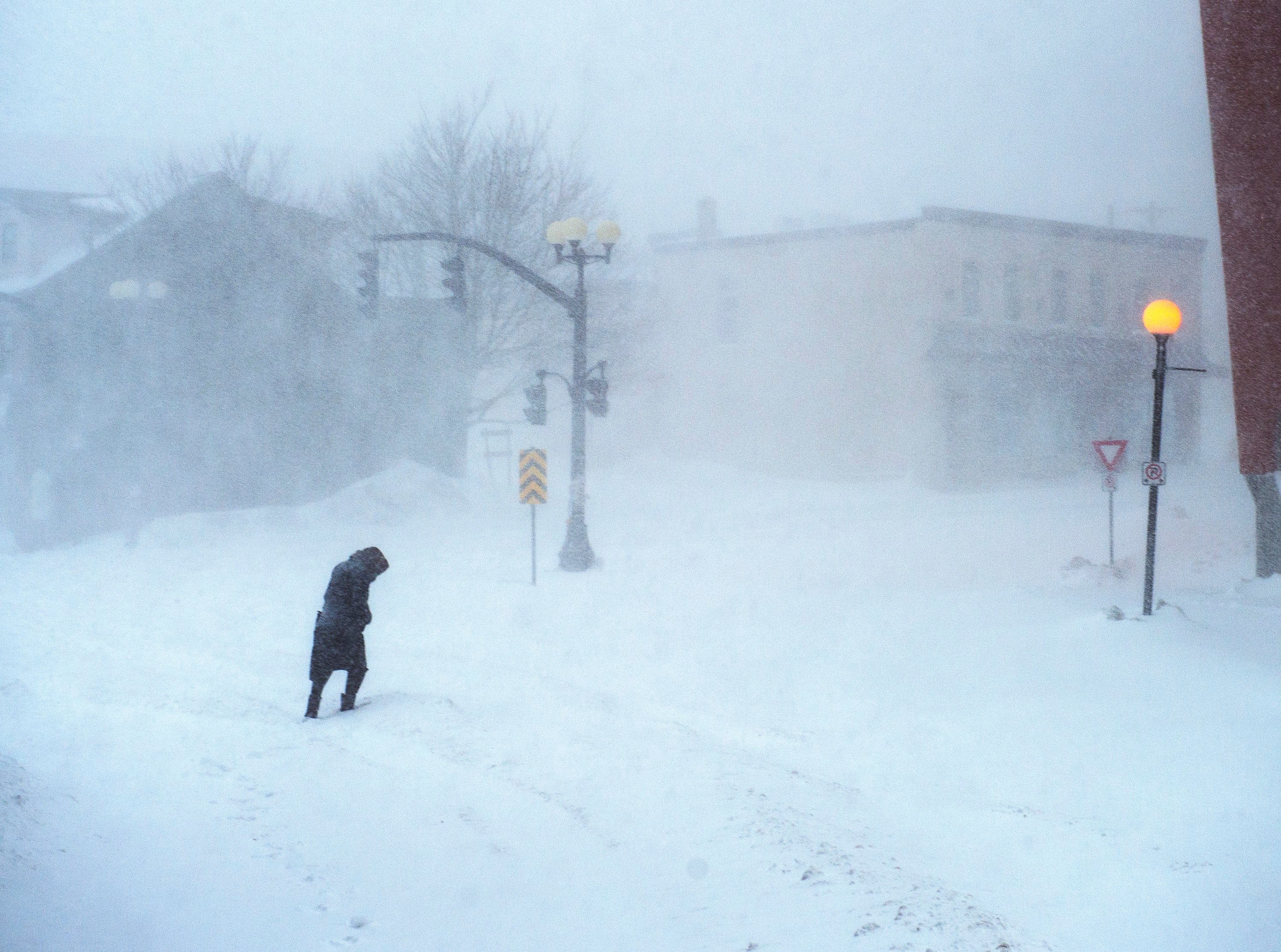 A woman makes her way through the snow-covered streets in St. John’s on Jan. 17, 2020 (CP/Andrew Vaughan