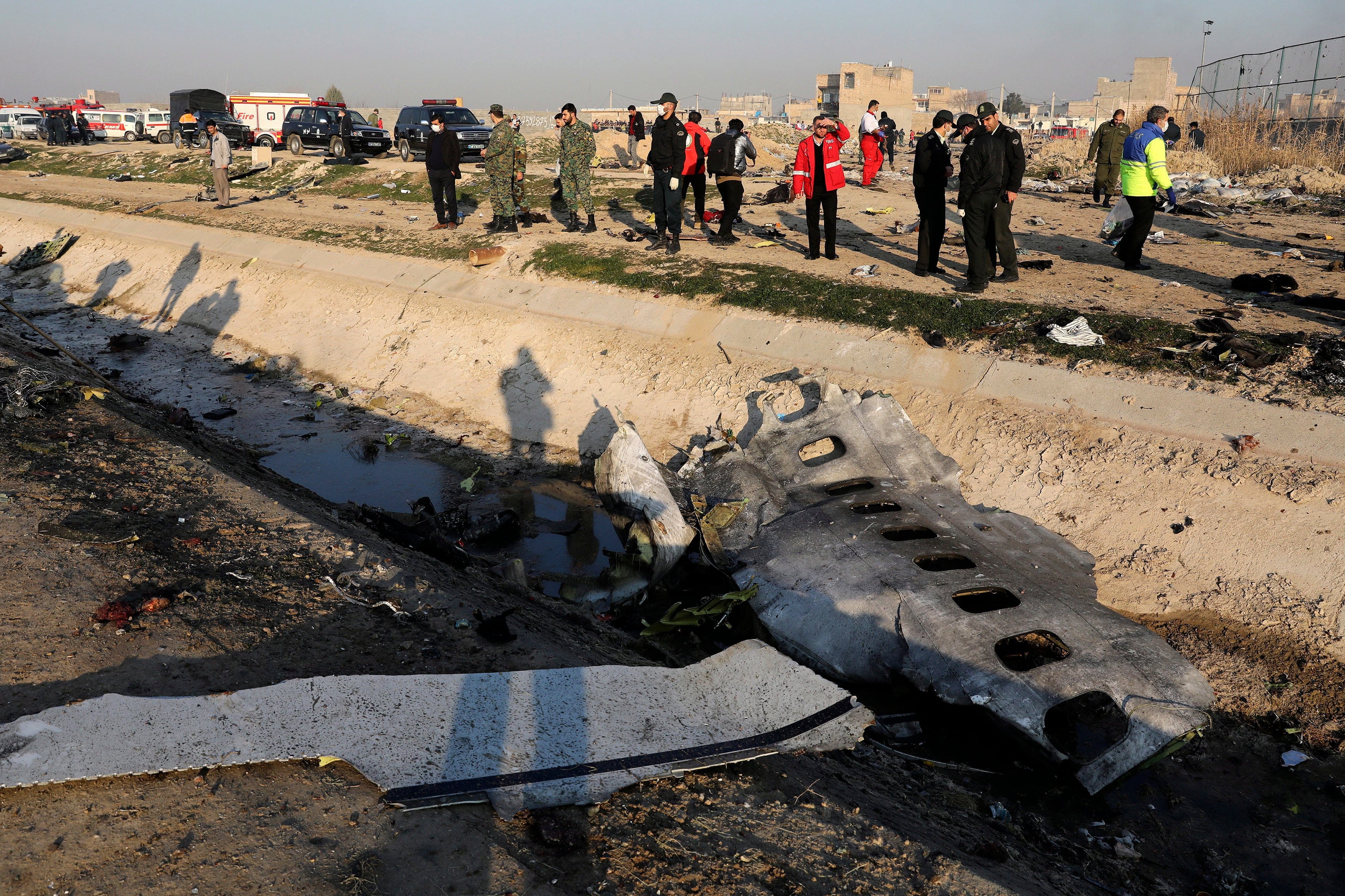 In this Jan. 8, 2020, photo, debris is seen from an Ukrainian plane which crashed as authorities work at the scene in Shahedshahr, southwest of the capital Tehran, Iran. (Ebrahim Noroozi/AP File Photo/CP)