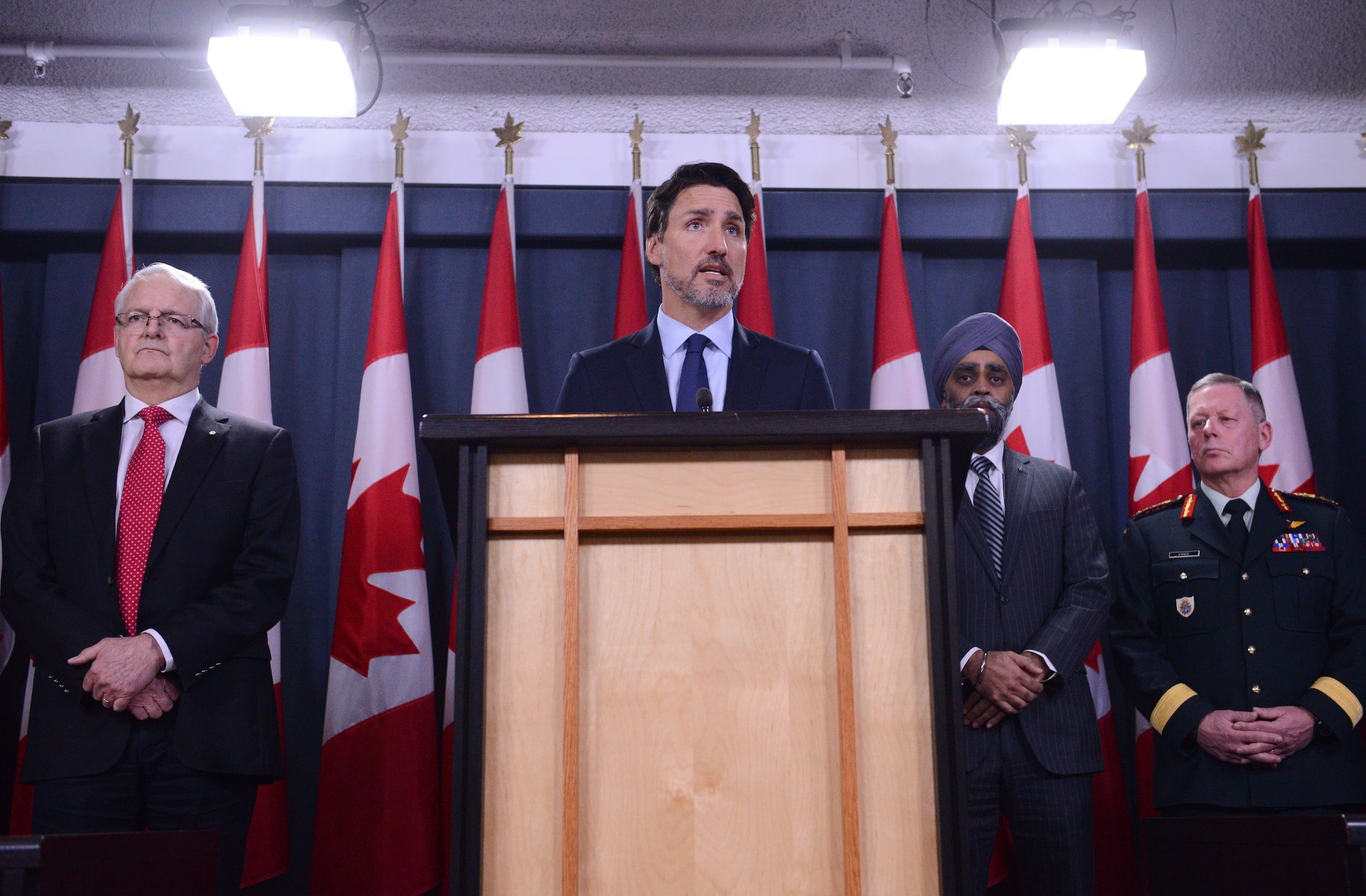 Prime Minister Justin Trudeau holds a press conference in Ottawa on Wednesday, Jan. 8, 2020, flanked by Transport Minister Marc Garneau (left), Defence Minister Harjit Sajjan and Gen. Jonathan Vance. (Sean Kilpatrick/CP)