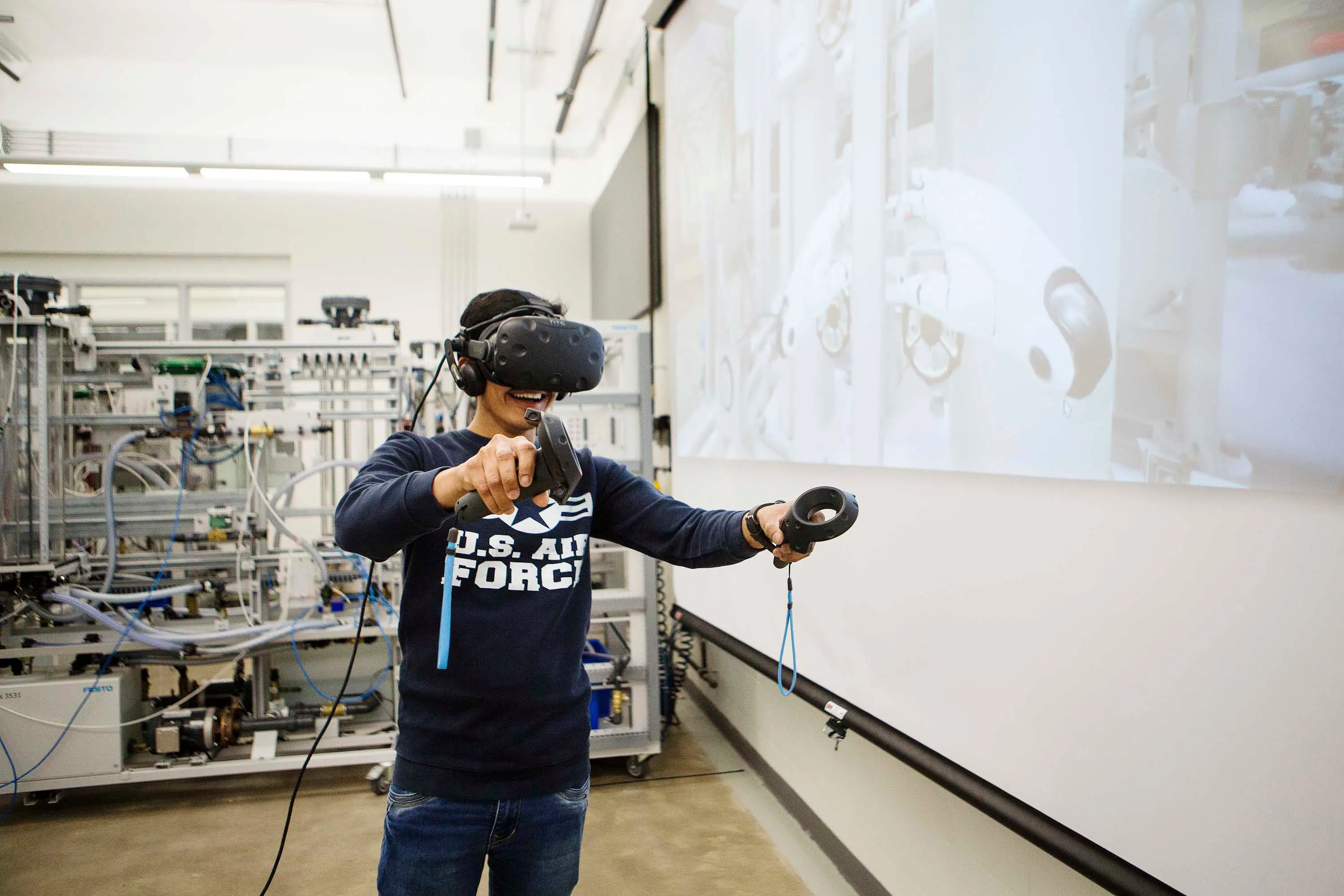 Mohammed Awaiskhan Pathan wears an HTC Vive Virtual Reality headset as he virtually works in a mock up of a refinery. Pathan is graduating in 2019 from the Electrical Engineering Technician/Power at Mohawk College's Stoney Creek Campus for Skilled Trades. (Photograph by Della Rollins)