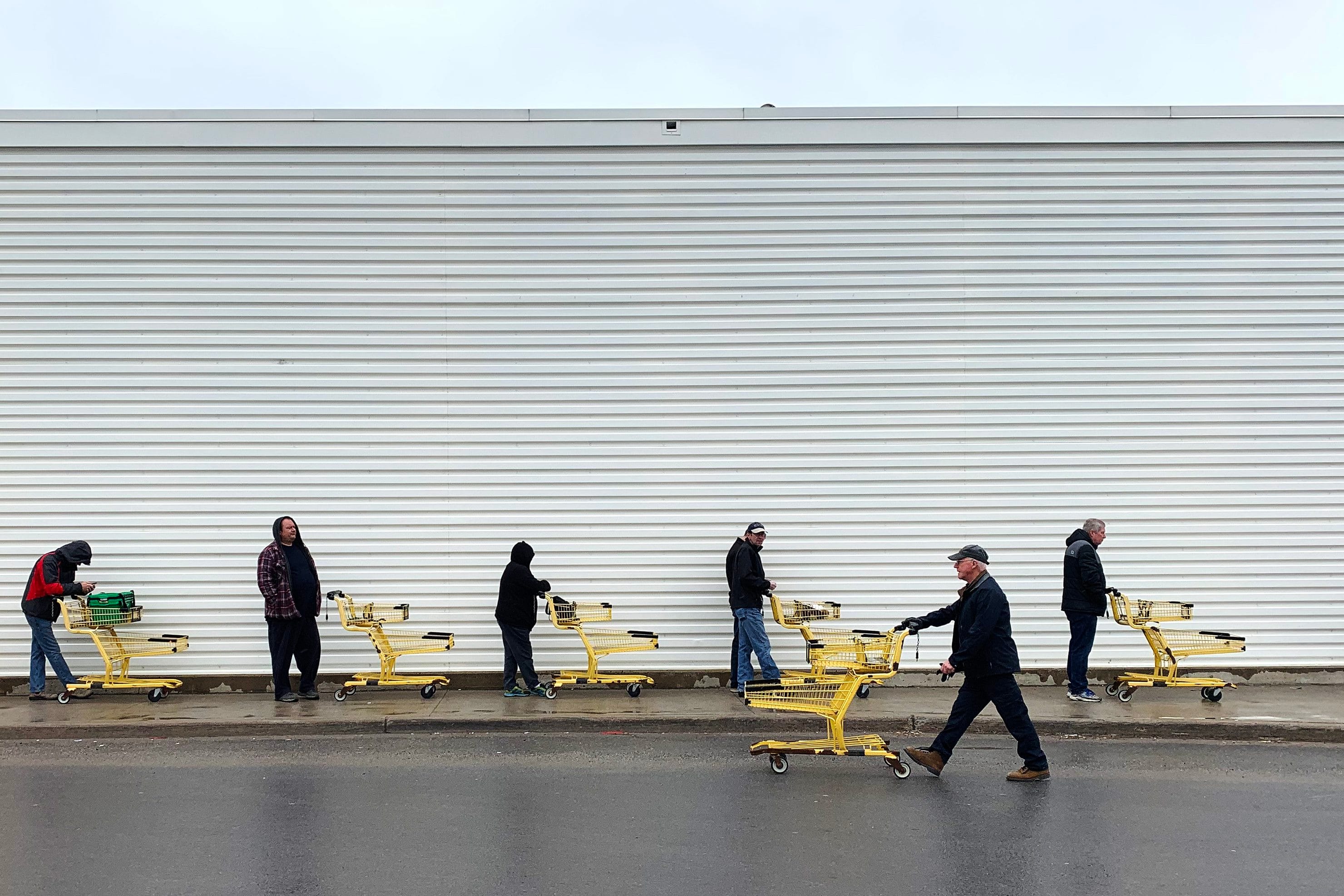 People use social distancing while they wait to get into the No Frills grocery store in Kingston, Ont. on Apr. 3, 2020. (Lars Hagberg/CP)