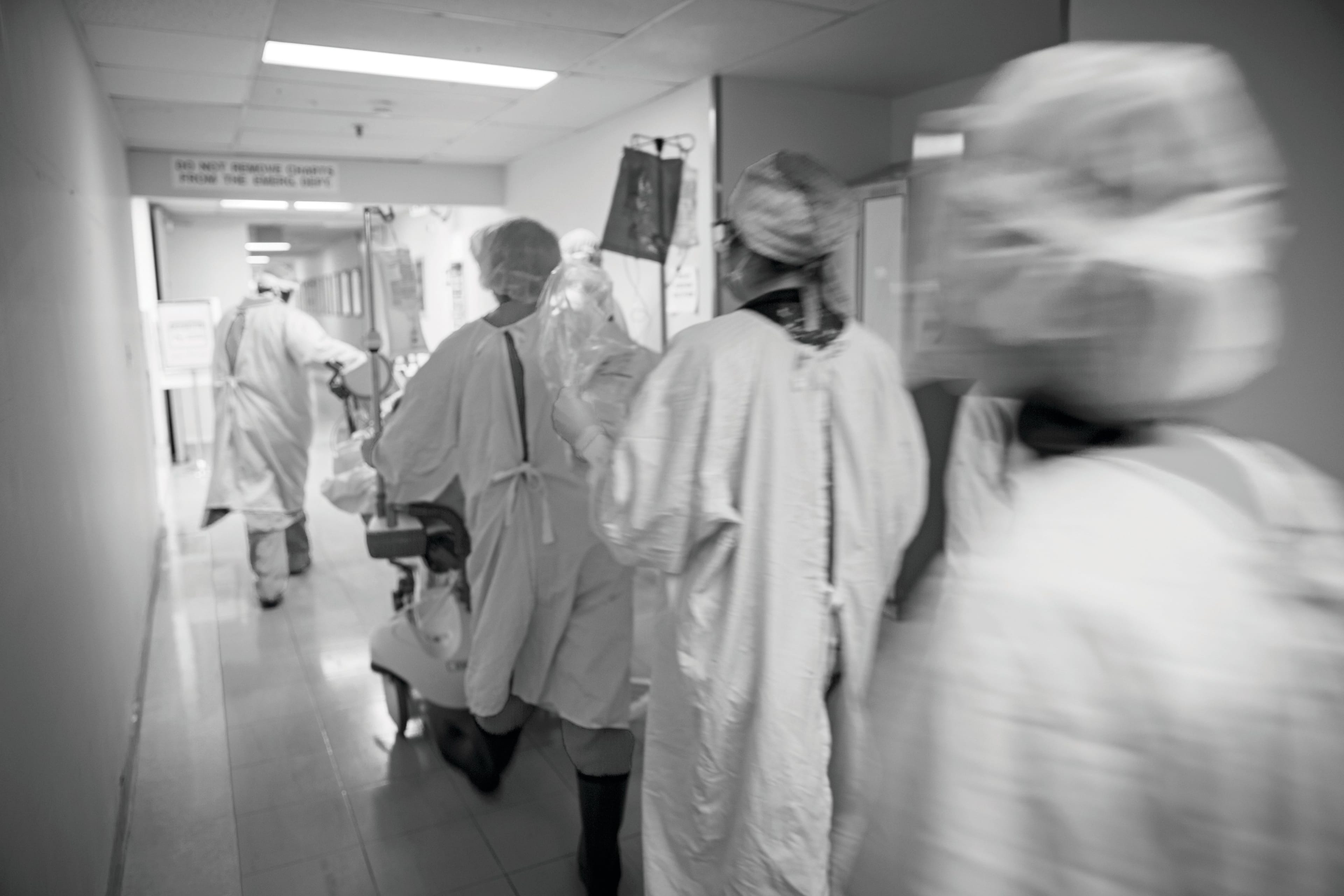 A patient with COVID-19 is rushed to the intensive care unit after being stabilized and having a breathing tube inserted. (Dr. Dawn Lim)