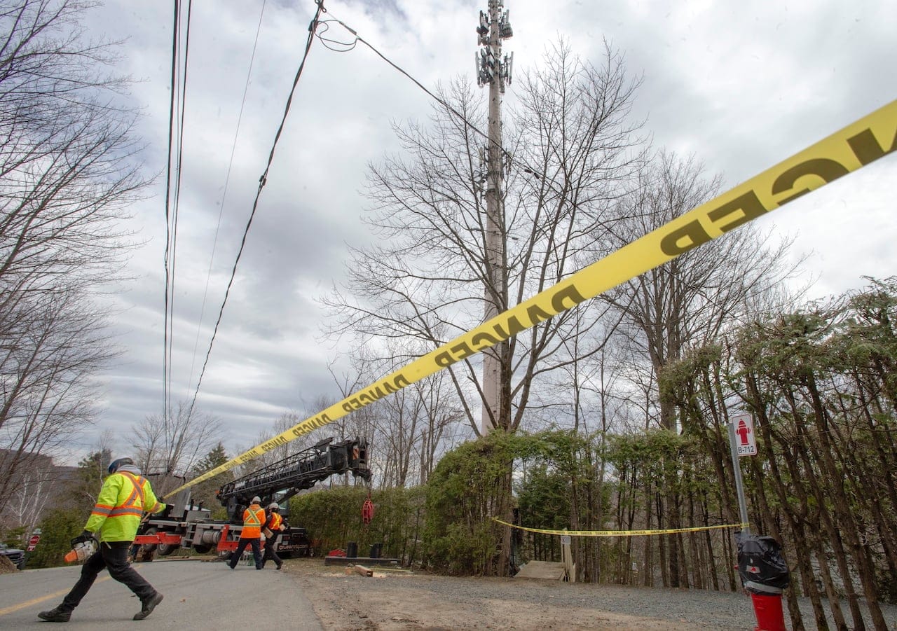 Technicians repair a cell tower after a fire that police are calling suspicious Monday May 4, 2020 in Piedmont, Que. (Ryan Remiorz/CP)