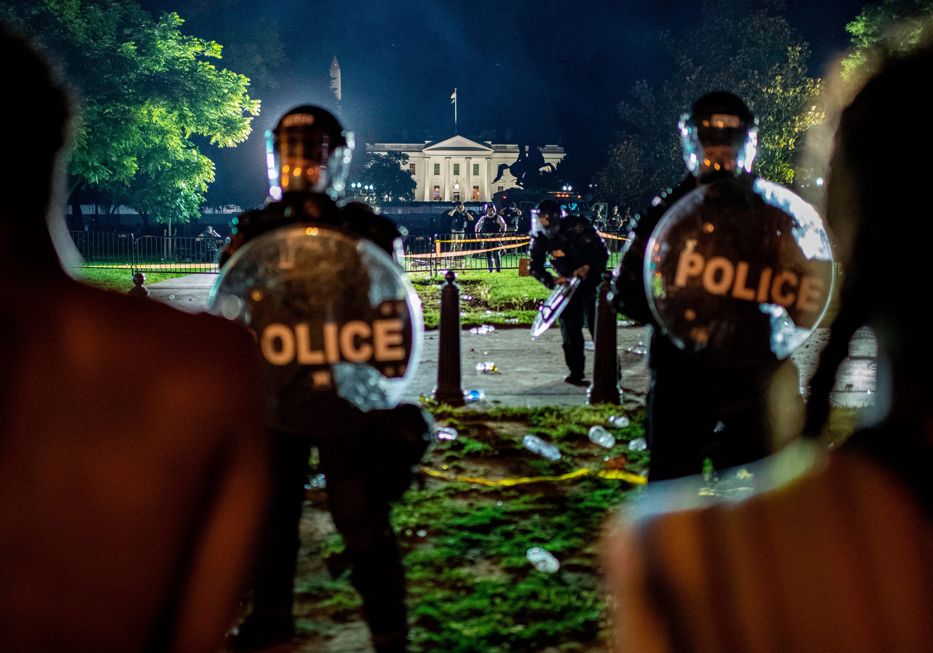 Demonstrators confront secret service police and Park police officers outside of the White House on May 30, 2020 in Washington DC, during a protest over the death of George Floyd, an unarmed black man, who died after a Minneapolis police officer kneeled on his neck for several minutes. - Demonstrations are being held across the US after George Floyd died in police custody on May 25. (Eric Baradat/AFP/Getty Images)