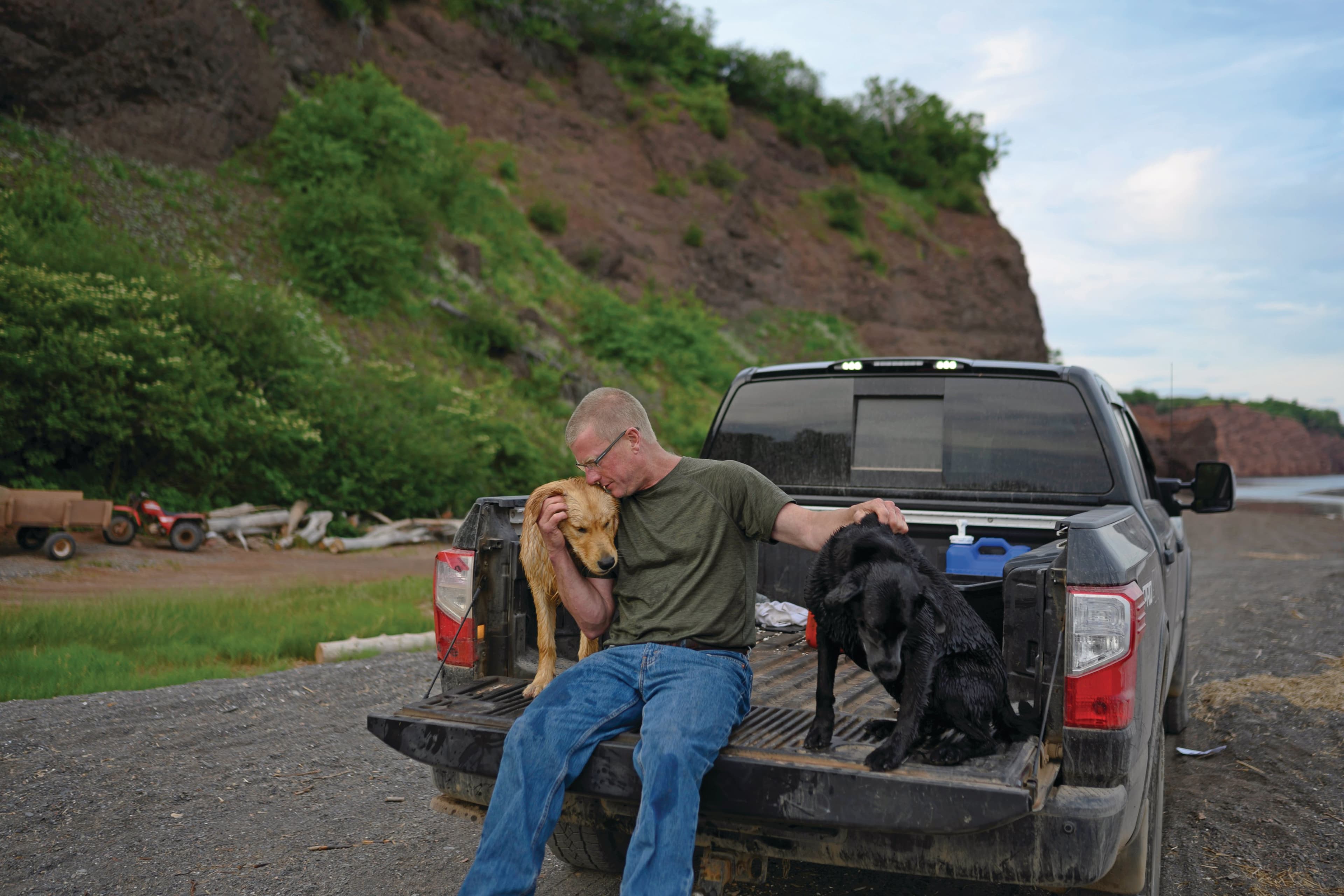 Joudrey, with dogs Yzerman (left) and Basil, wonders why the RCMP didn’t evacuate Portapique (Photograph by Darren Calabrese)