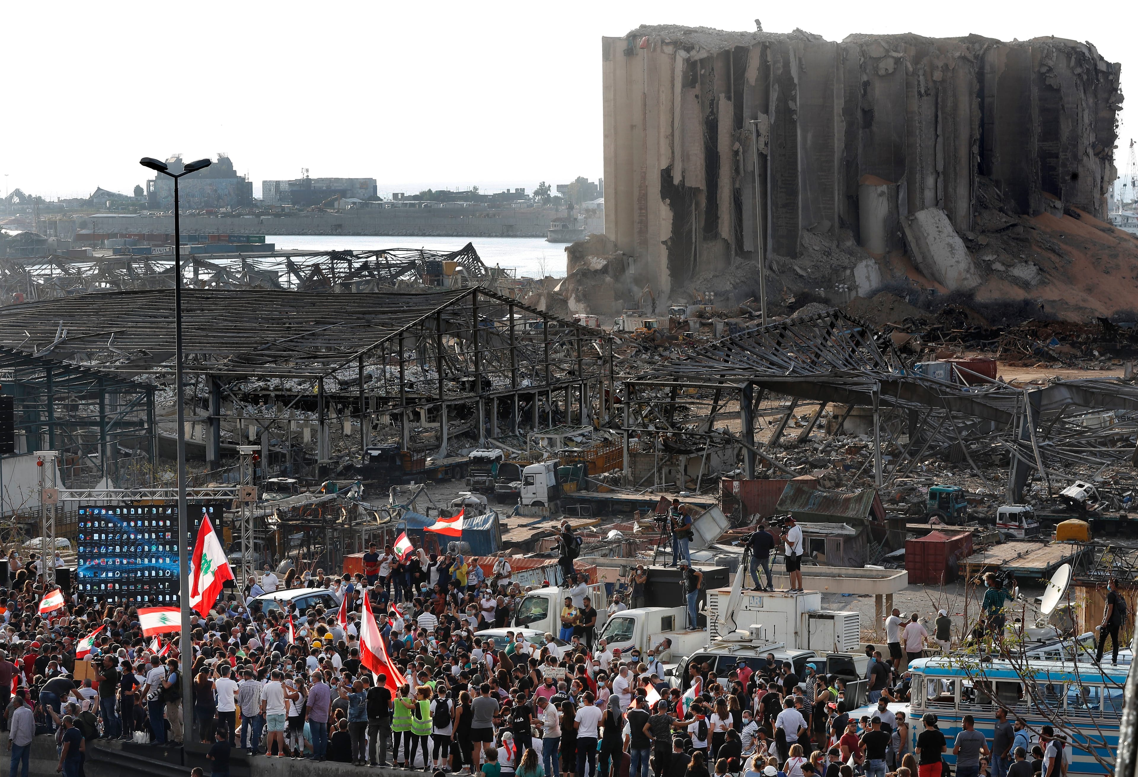 People gather Tuesday to honour victims of last week's explosion that killed more than 200 and devastated the city. (Hussein Malla/AP)