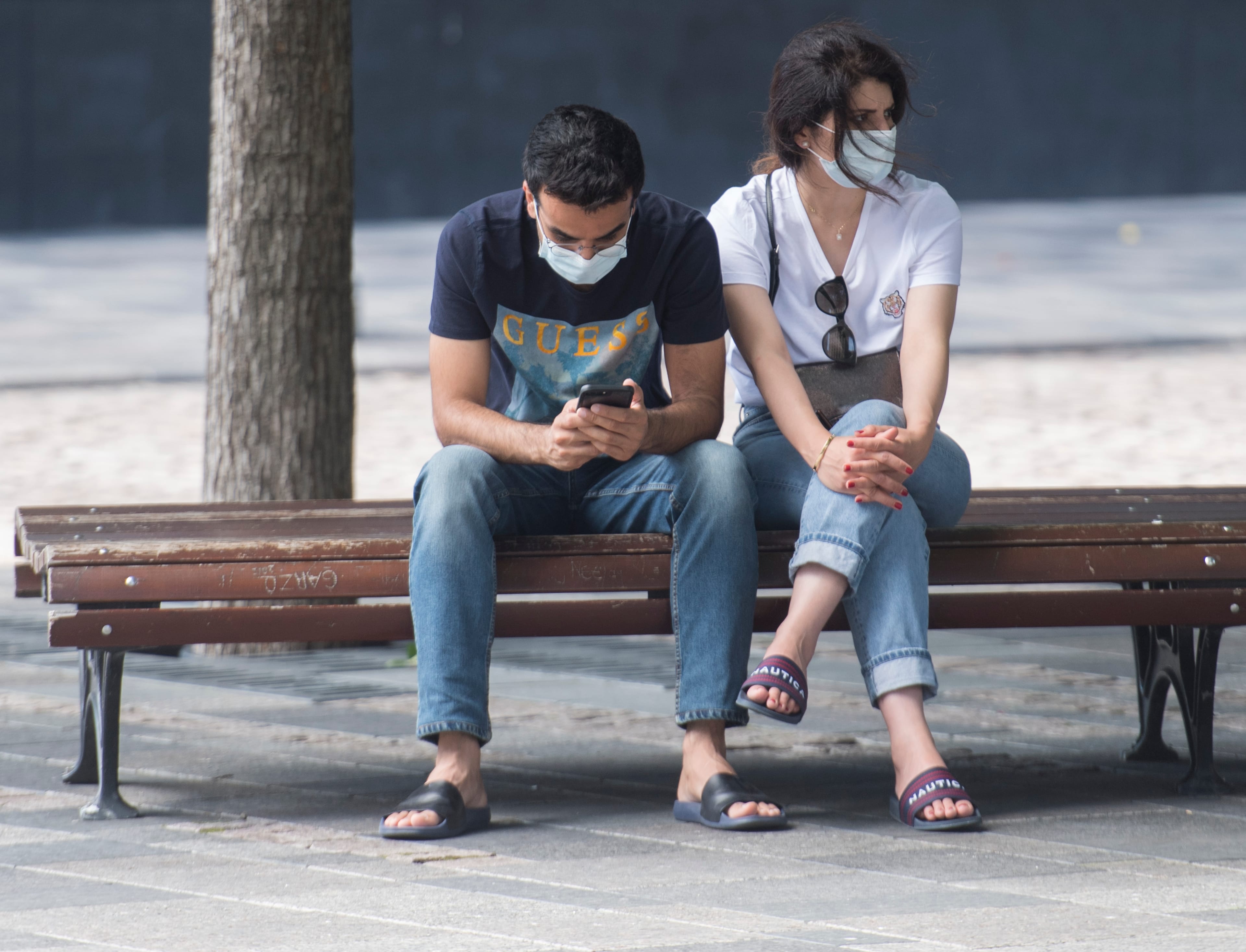 People wear face masks on a street in Montreal. (Graham Hughes/CP)