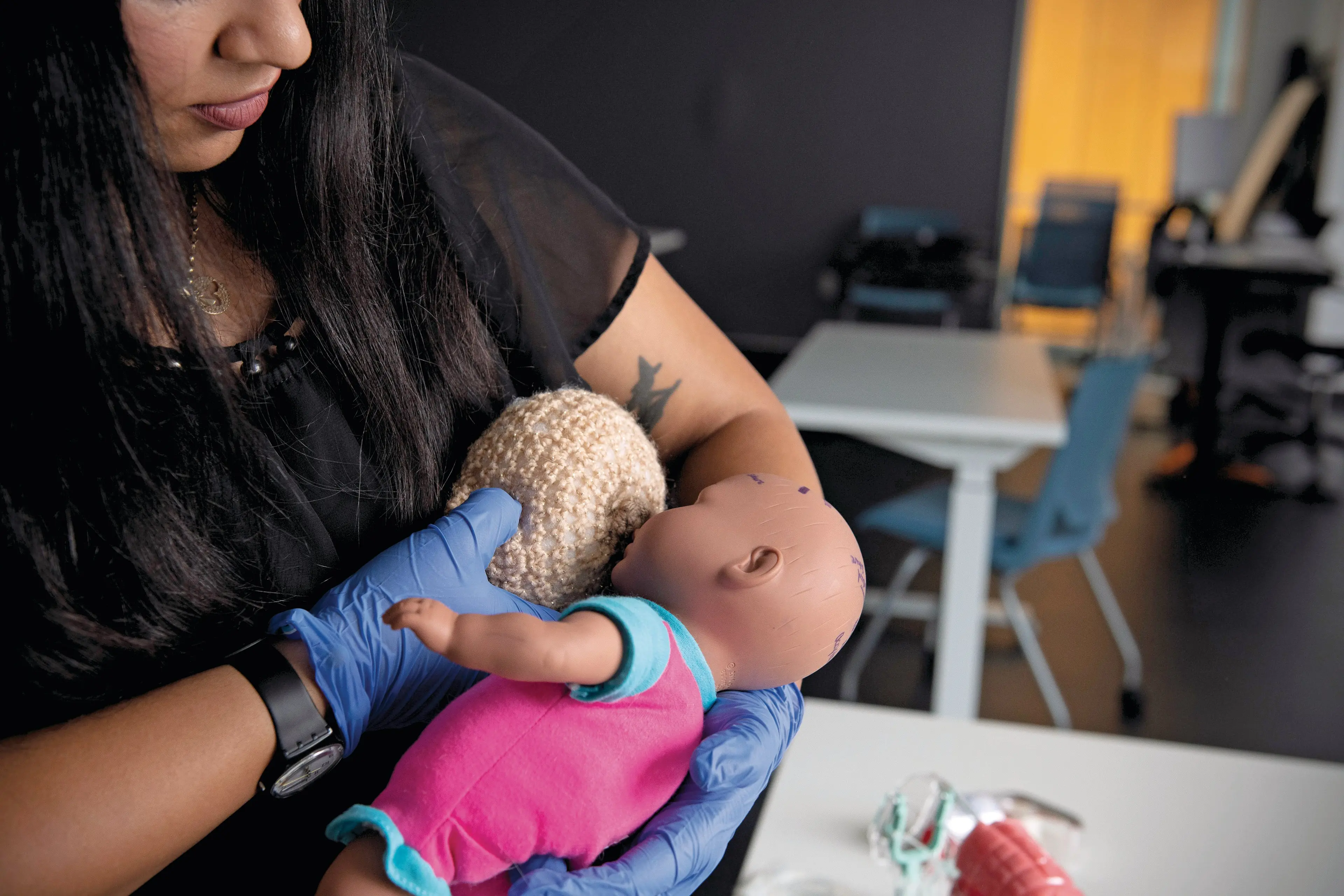 Maryam demonstrates breastfeeding on a mock breast (Photograph by Kiana Hayeri)