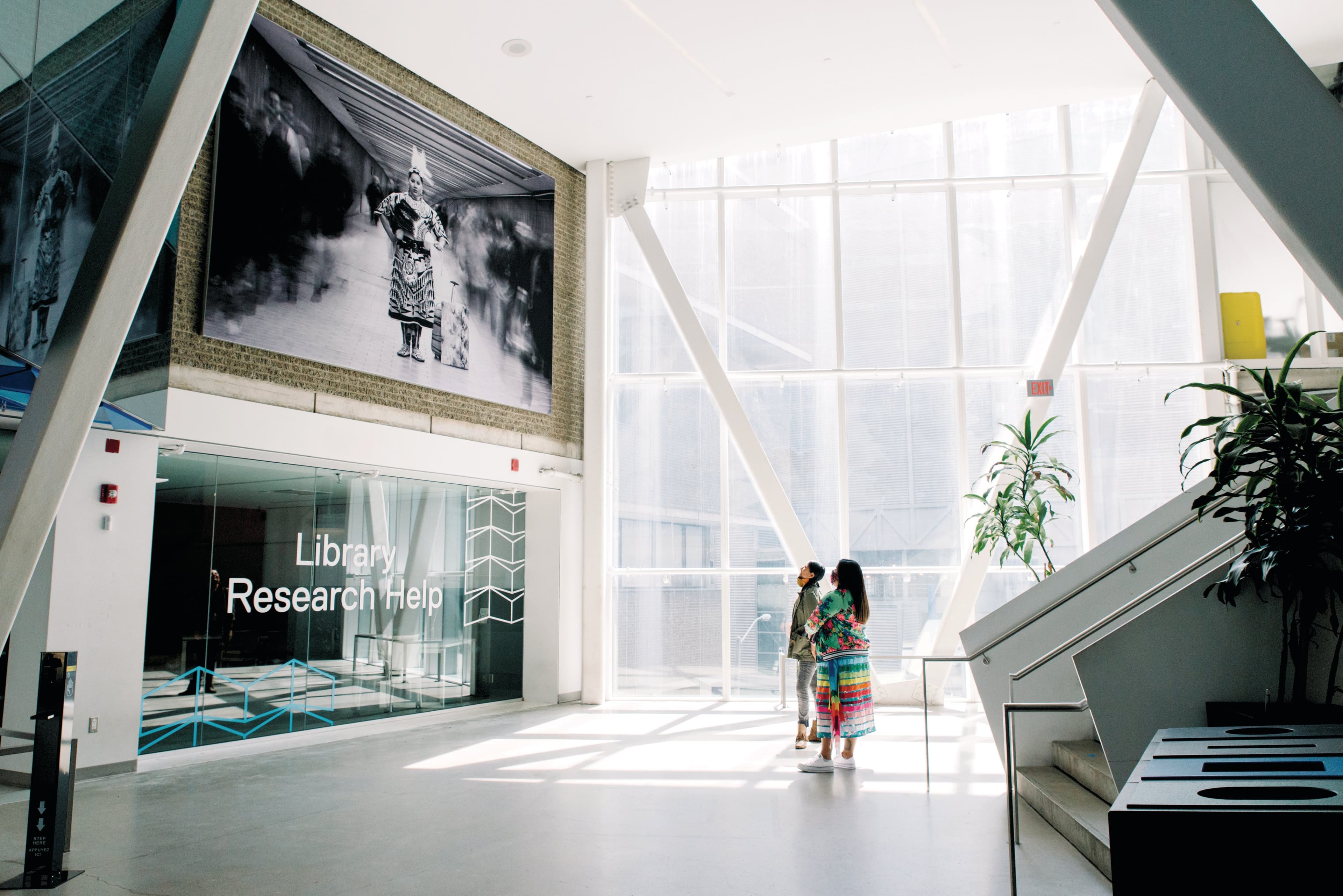 Kwandibens (left) and Tee Lyn Duke beside the installation of Kwandibens’ work on Ryerson campus (Stef & Ethan)