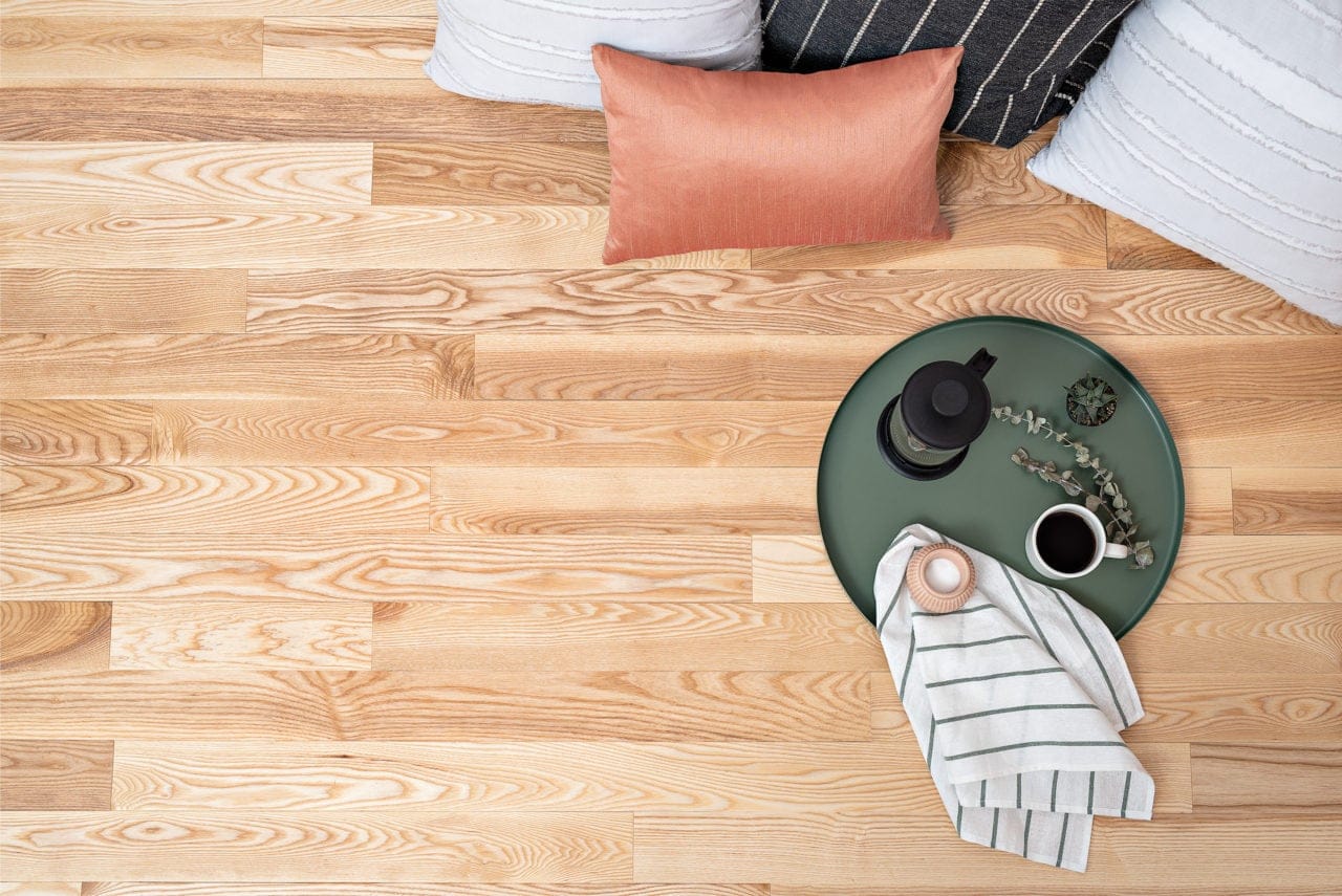Tray of coffee sitting on hardwood floor