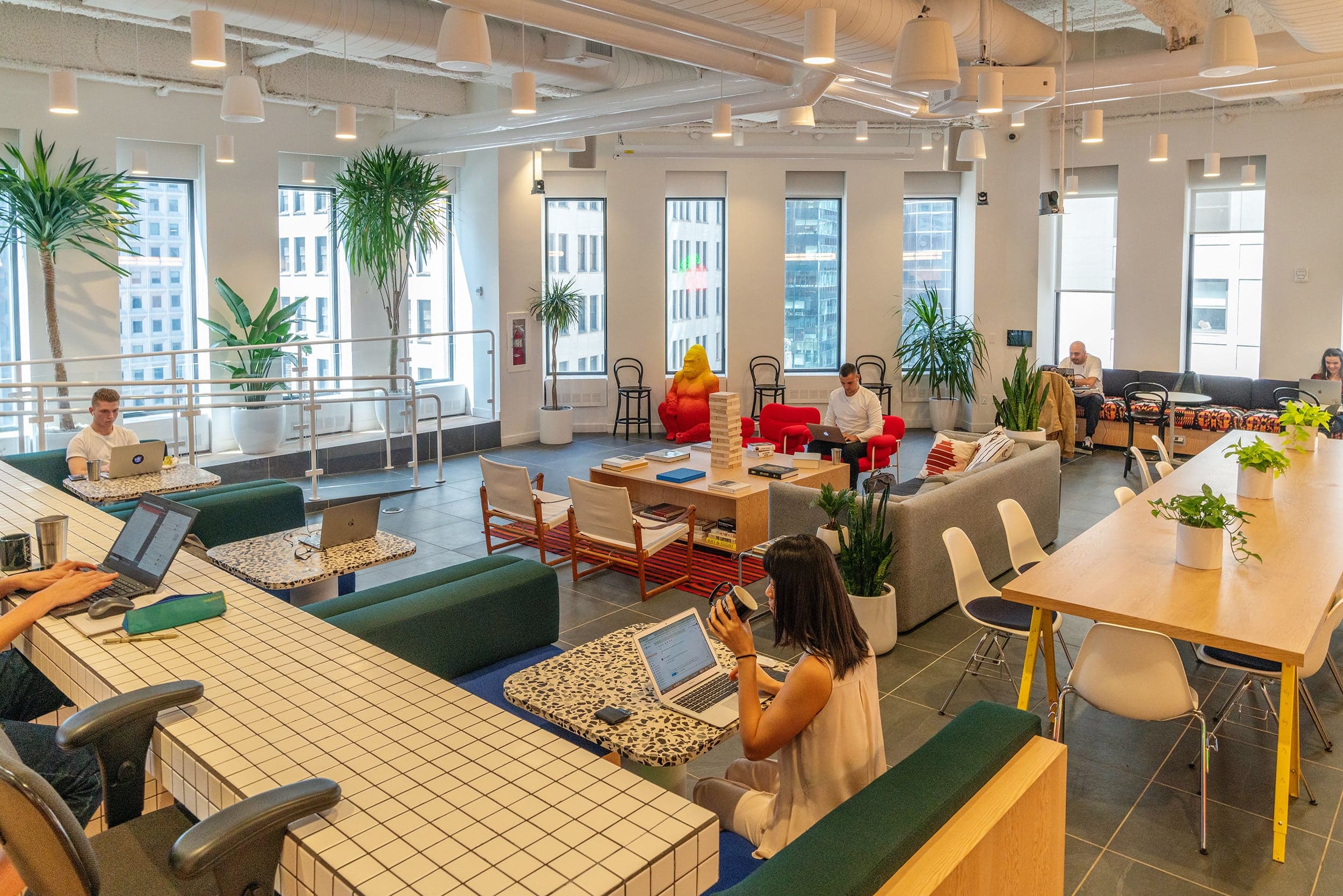 Members at a WeWork co-working space in NYC; at its peak, the company had 280 locations (David 'Dee' Delgado/Bloomberg/Getty Images)